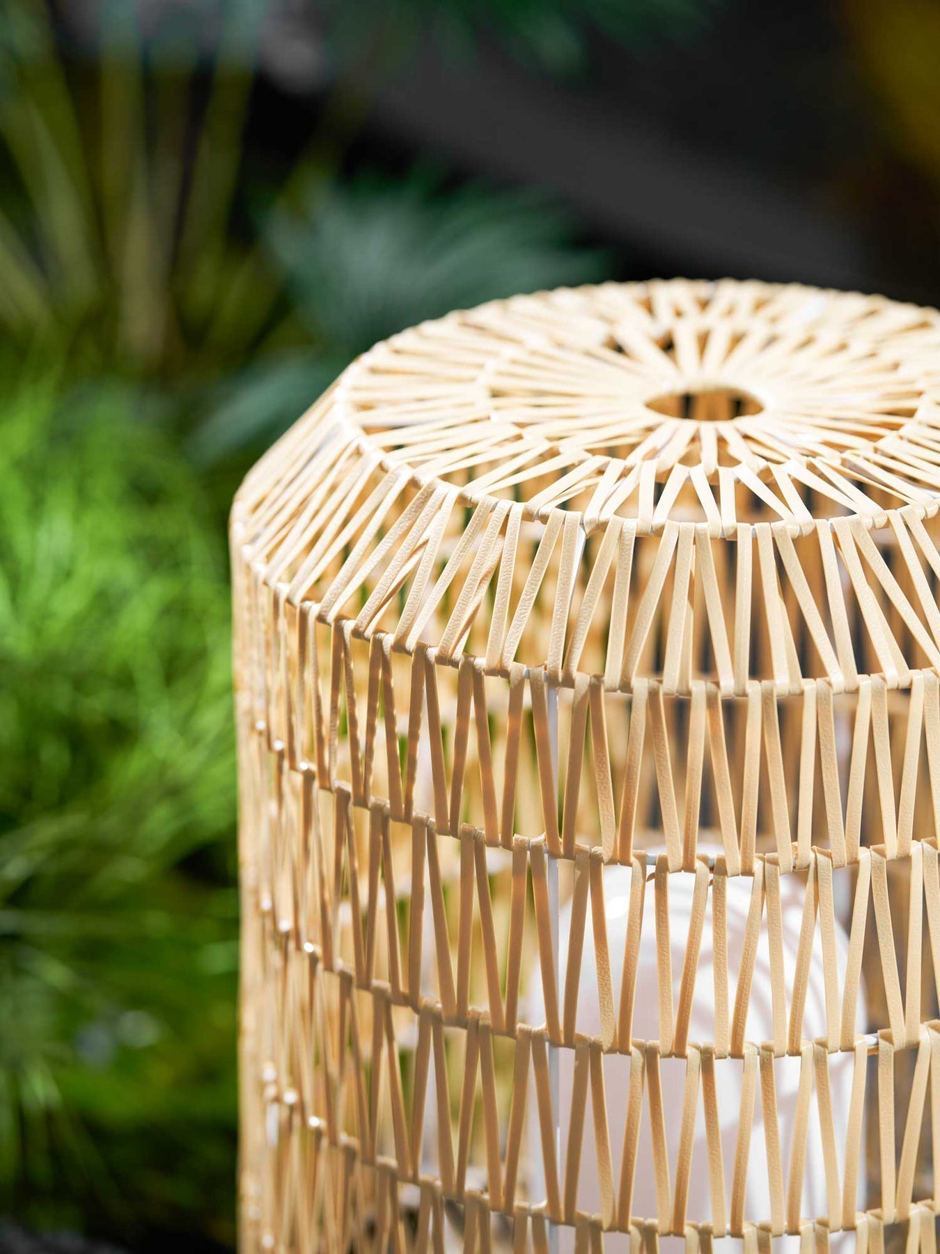 Woven rattan lamp styled on a modern outdoor deck.