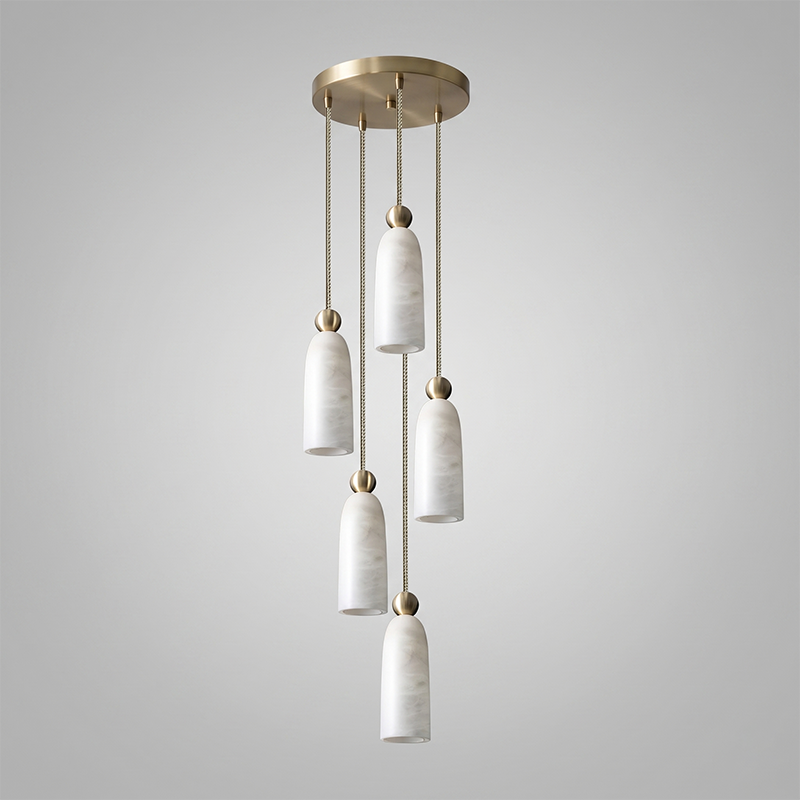 The hand-carved cylindrical form of the alabaster shade.