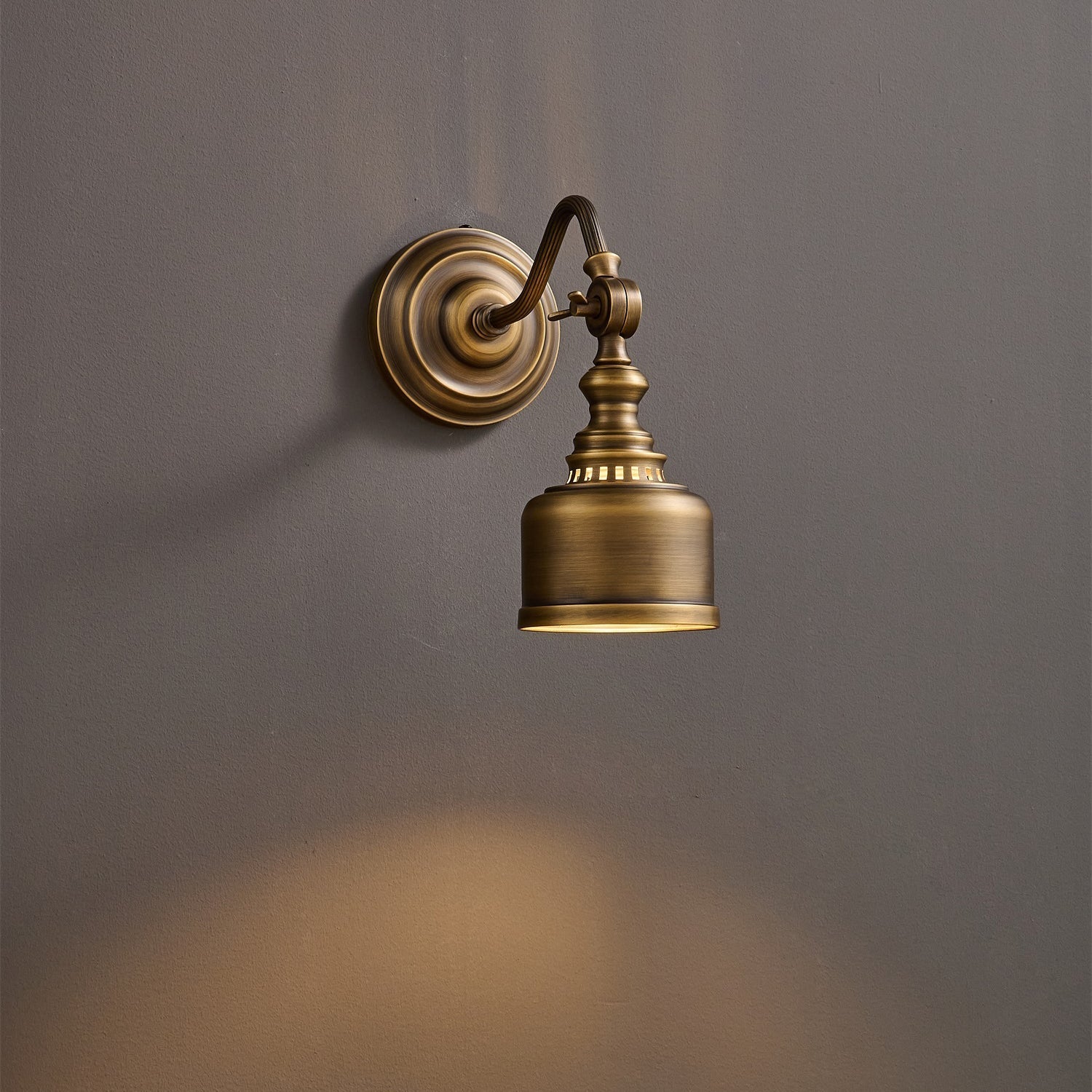 Close-up of the hand-aged antique brass finish texture.