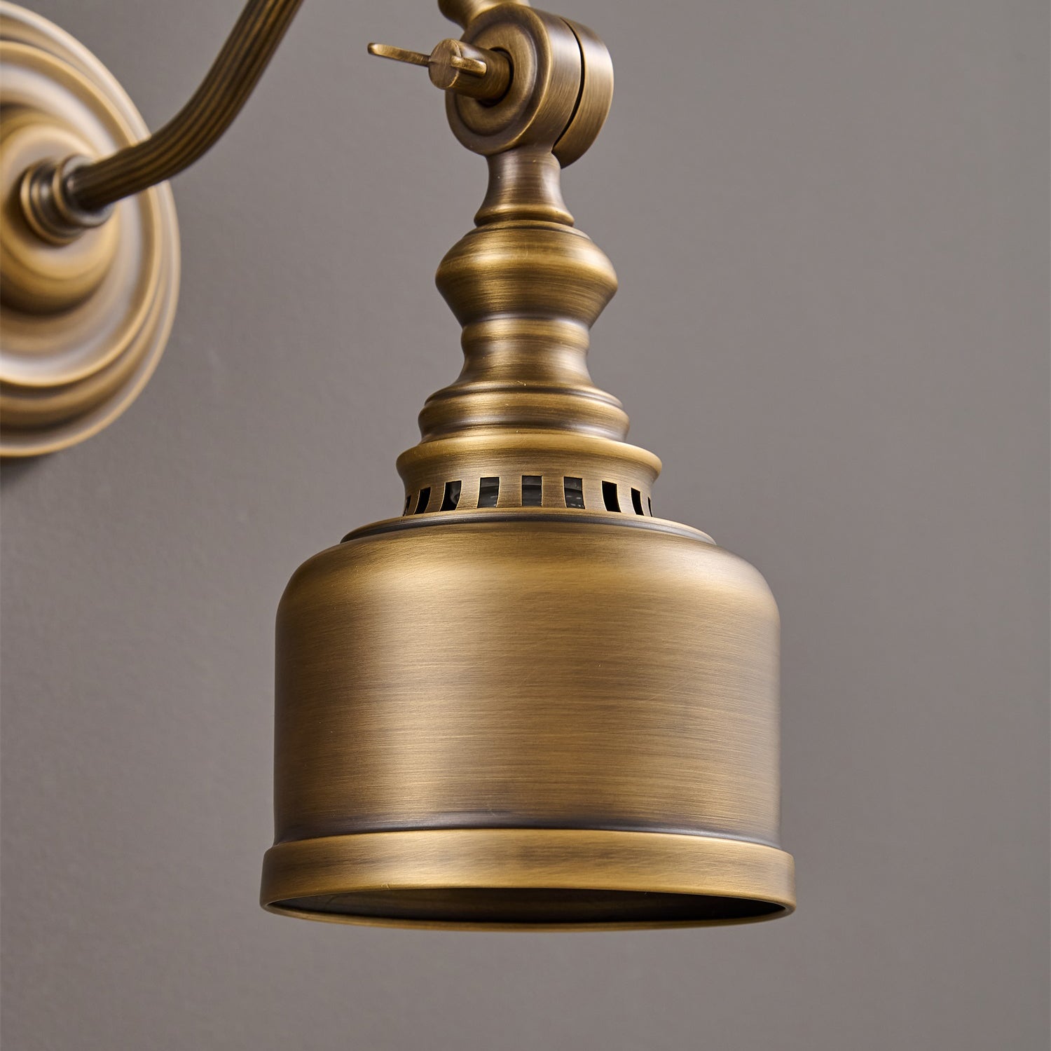 The lamp installed over a small desk in a workshop.