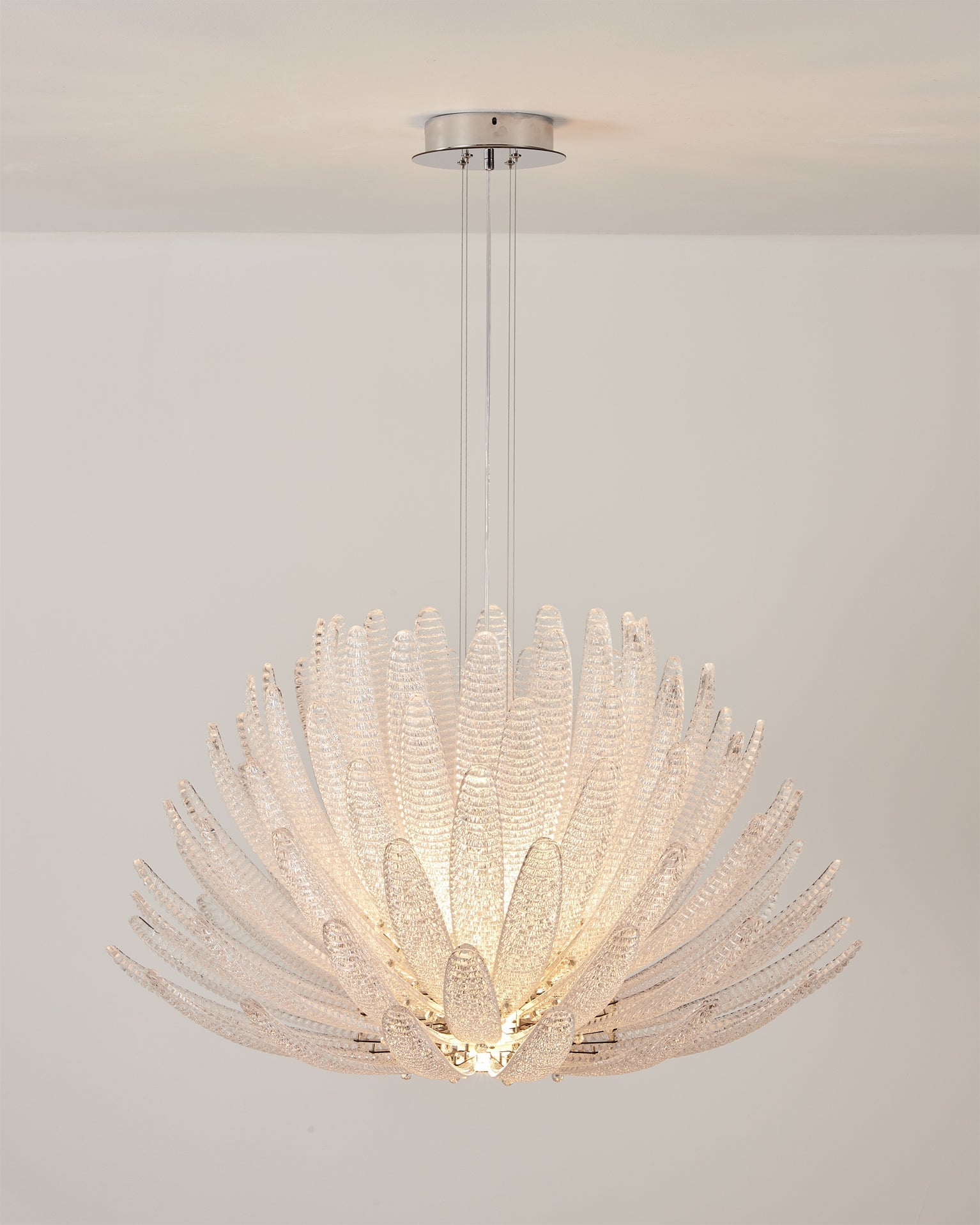 View from below the Agave Starburst Chandelier, showing the radiating glass petals.