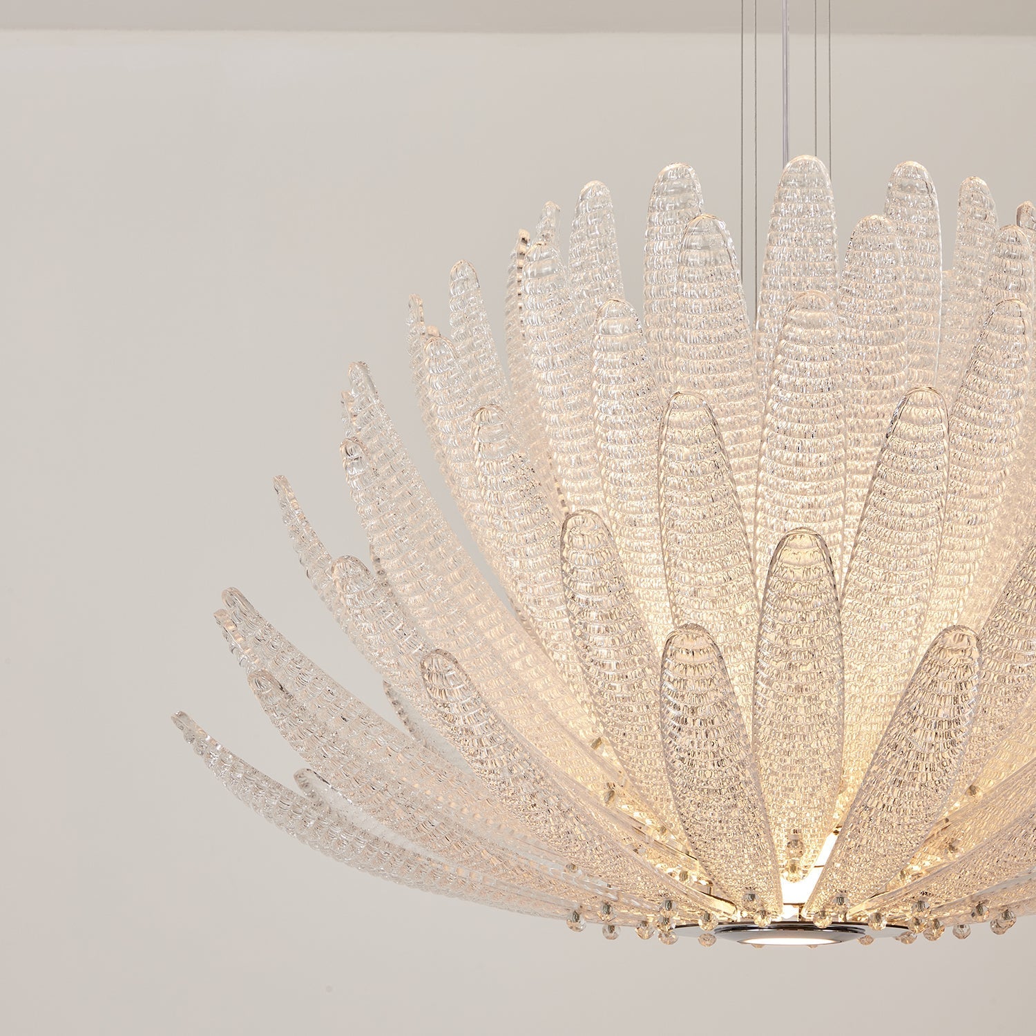 Detailed view of a single clear glass petal from the Agave Chandelier.