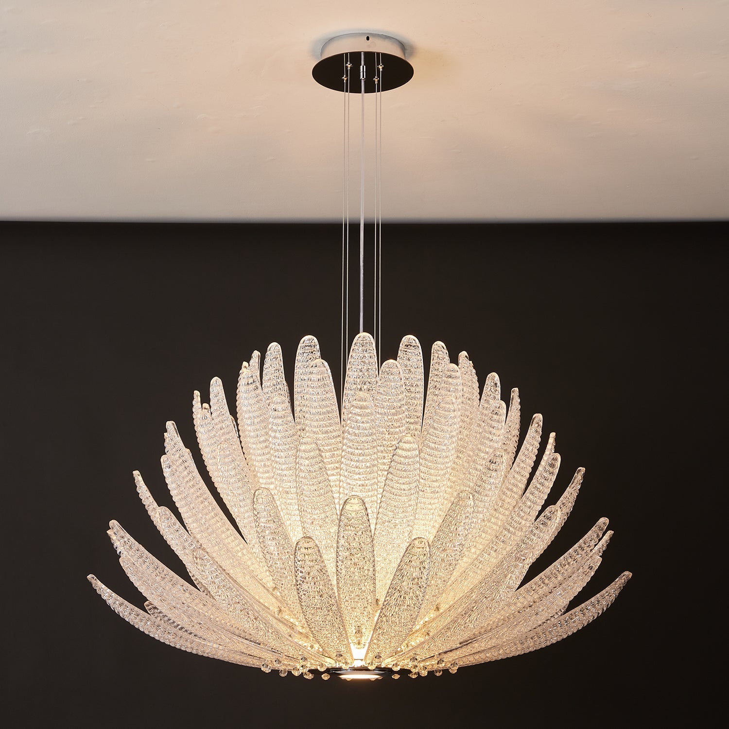 Detailed view of a single amber glass petal from the Agave Chandelier.