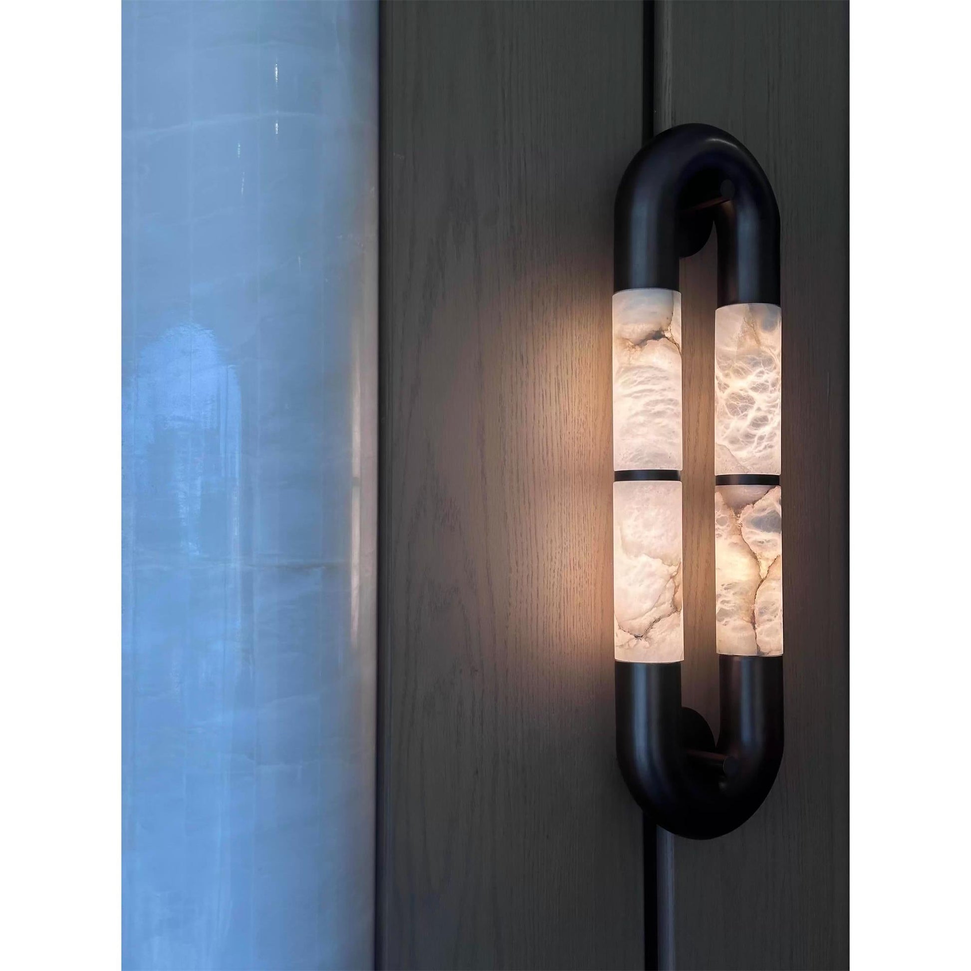 Angled view of the black sconce.
