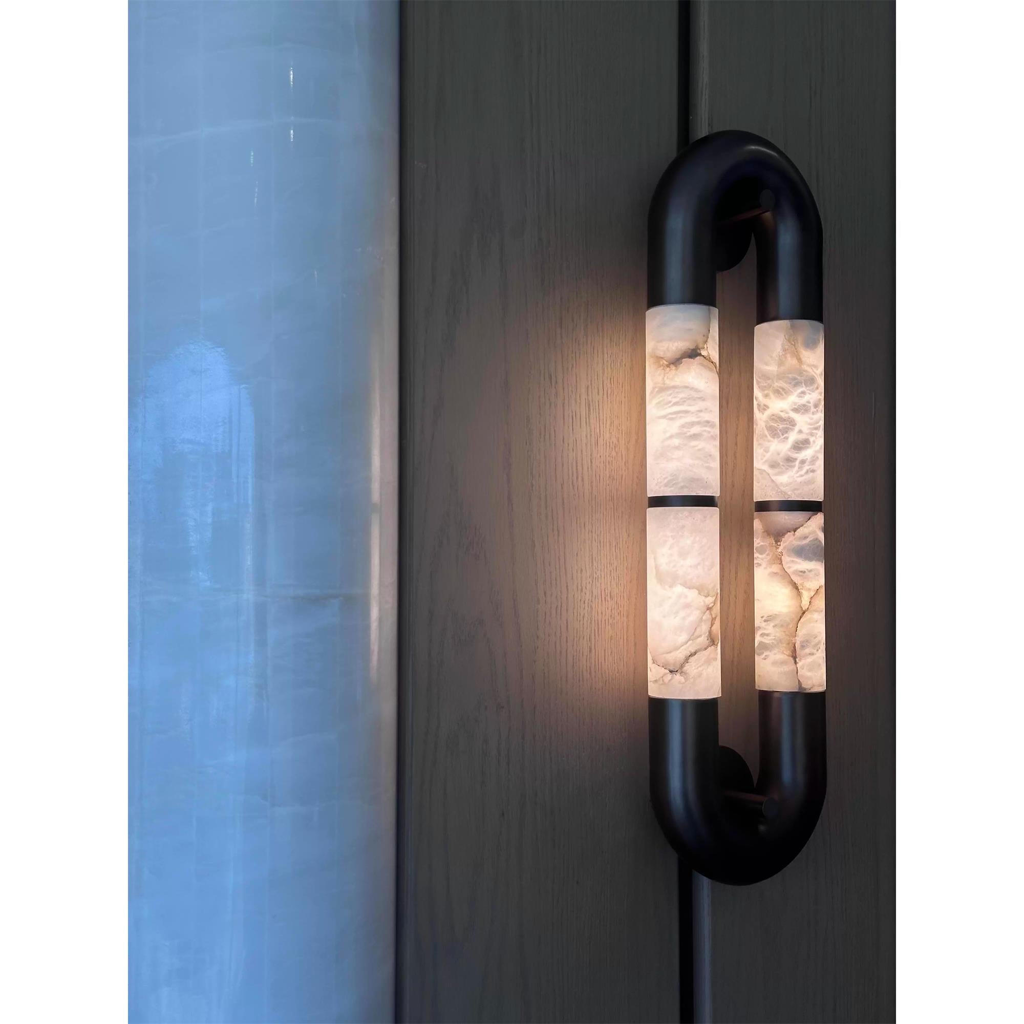 Angled view of the black sconce.