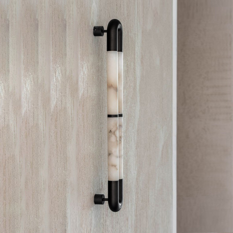 The sconce installed as a pair on either side of a mirror.