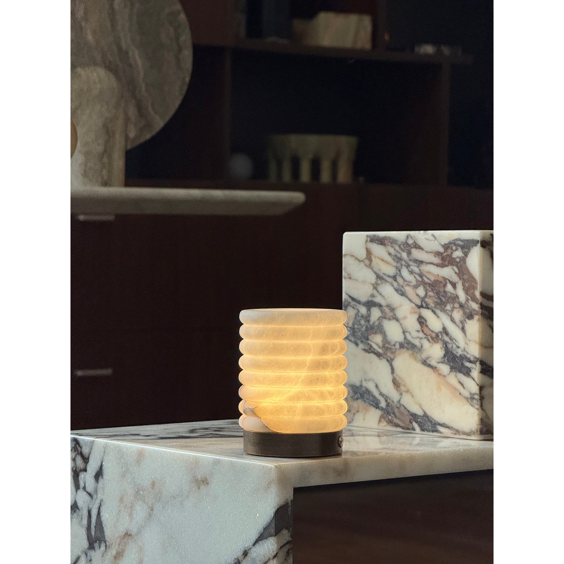 Three finishes of the alabaster table lamp: dark bronze, white, and brown, shown side-by-side.