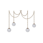 Alabaster Swag Pendant Lamp with multiple globes over a dining table.