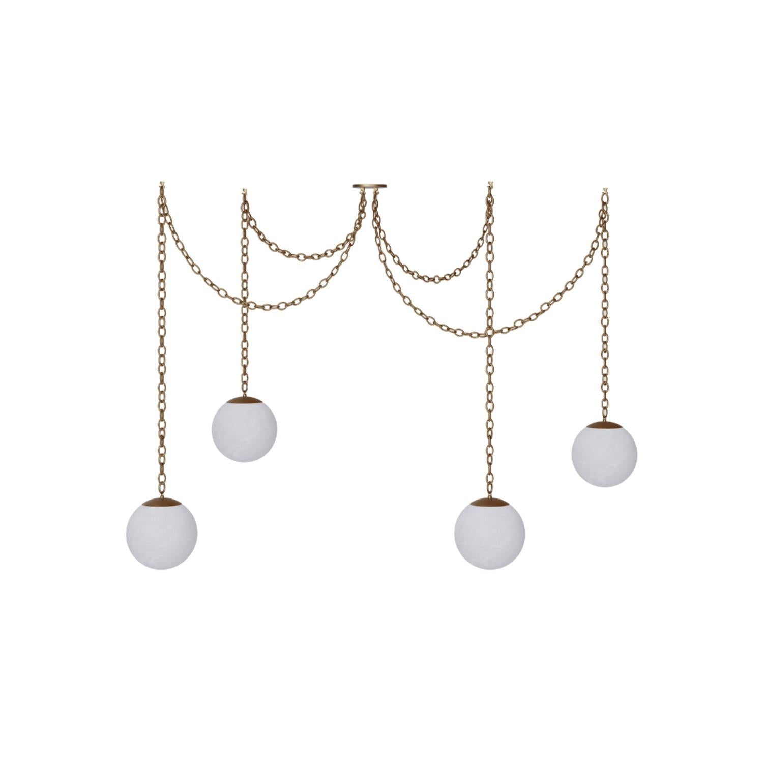 Alabaster Swag Pendant Lamp with multiple globes over a dining table.