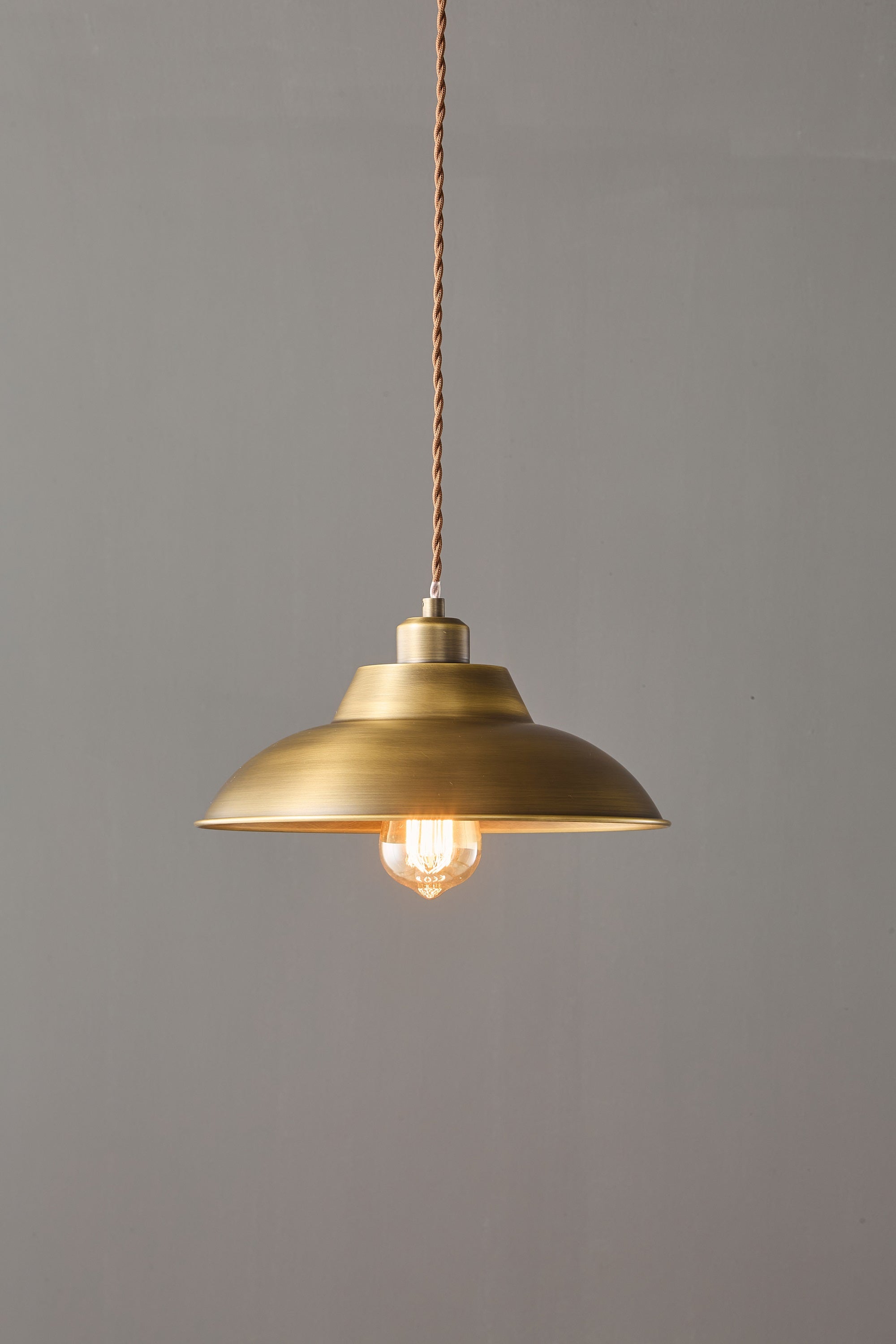 The lamp shown in a dining room setting over a table.