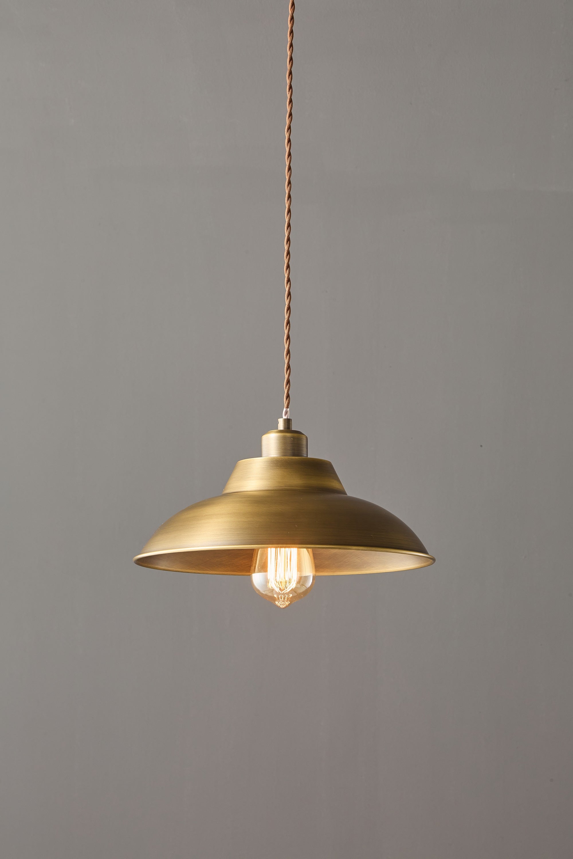 Aldorno Pendant Lamp adding ambiance to a minimalist bedroom.