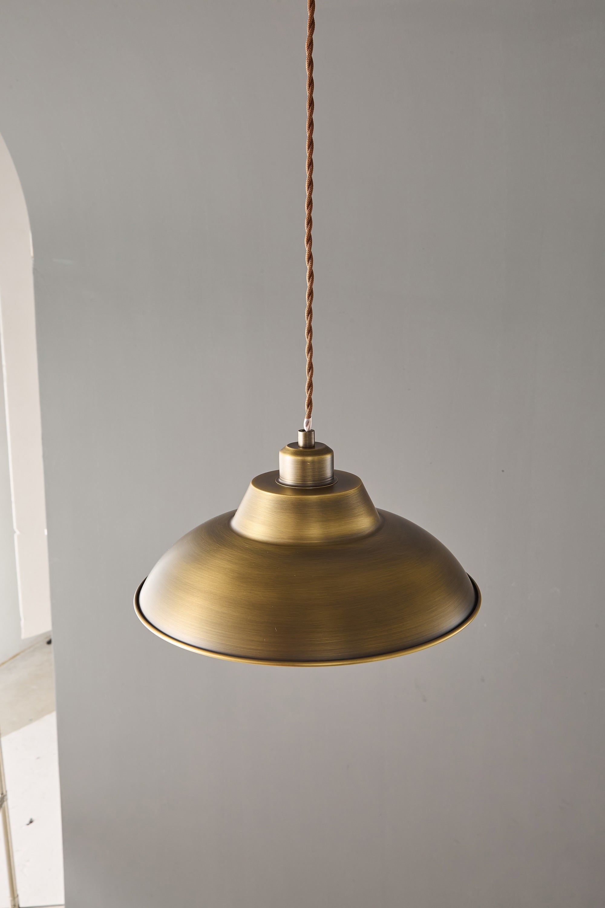 Aldorno Pendant Lamp against a dark background to highlight its unique shape.