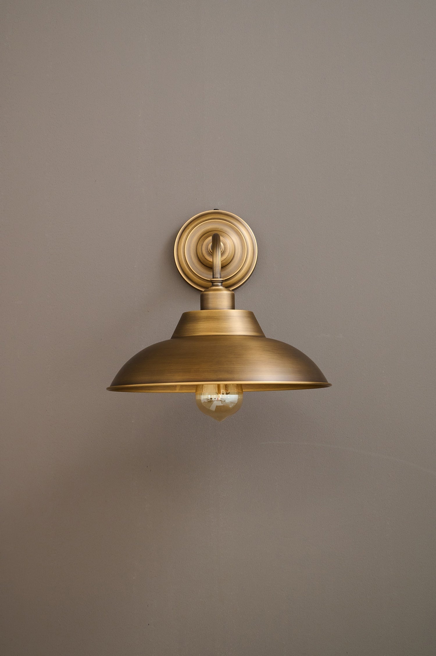Lifestyle image of the Aldorno Wall Sconce in a hallway.