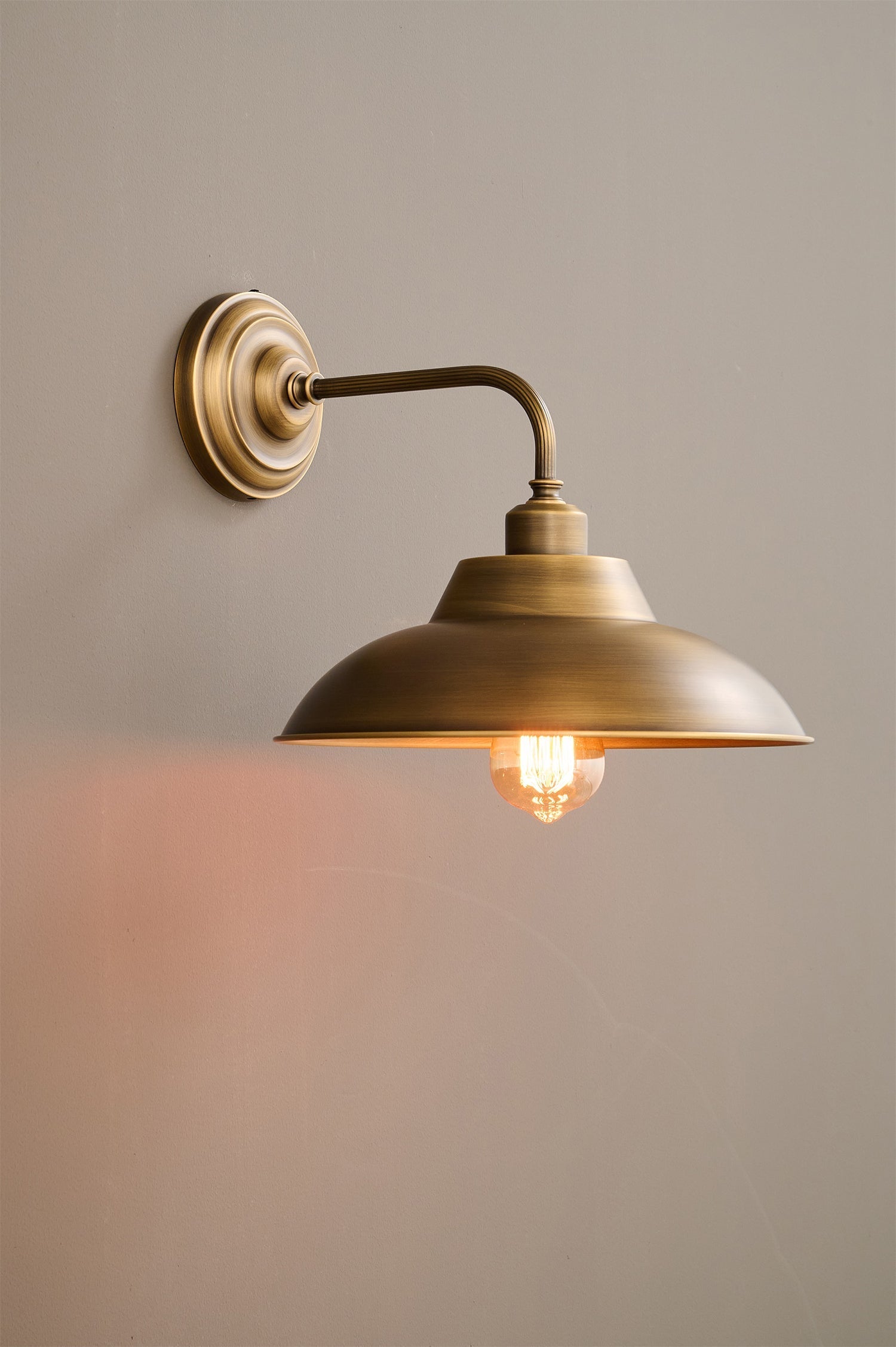 Aldorno Wall Sconce providing ambient light in a dining area.