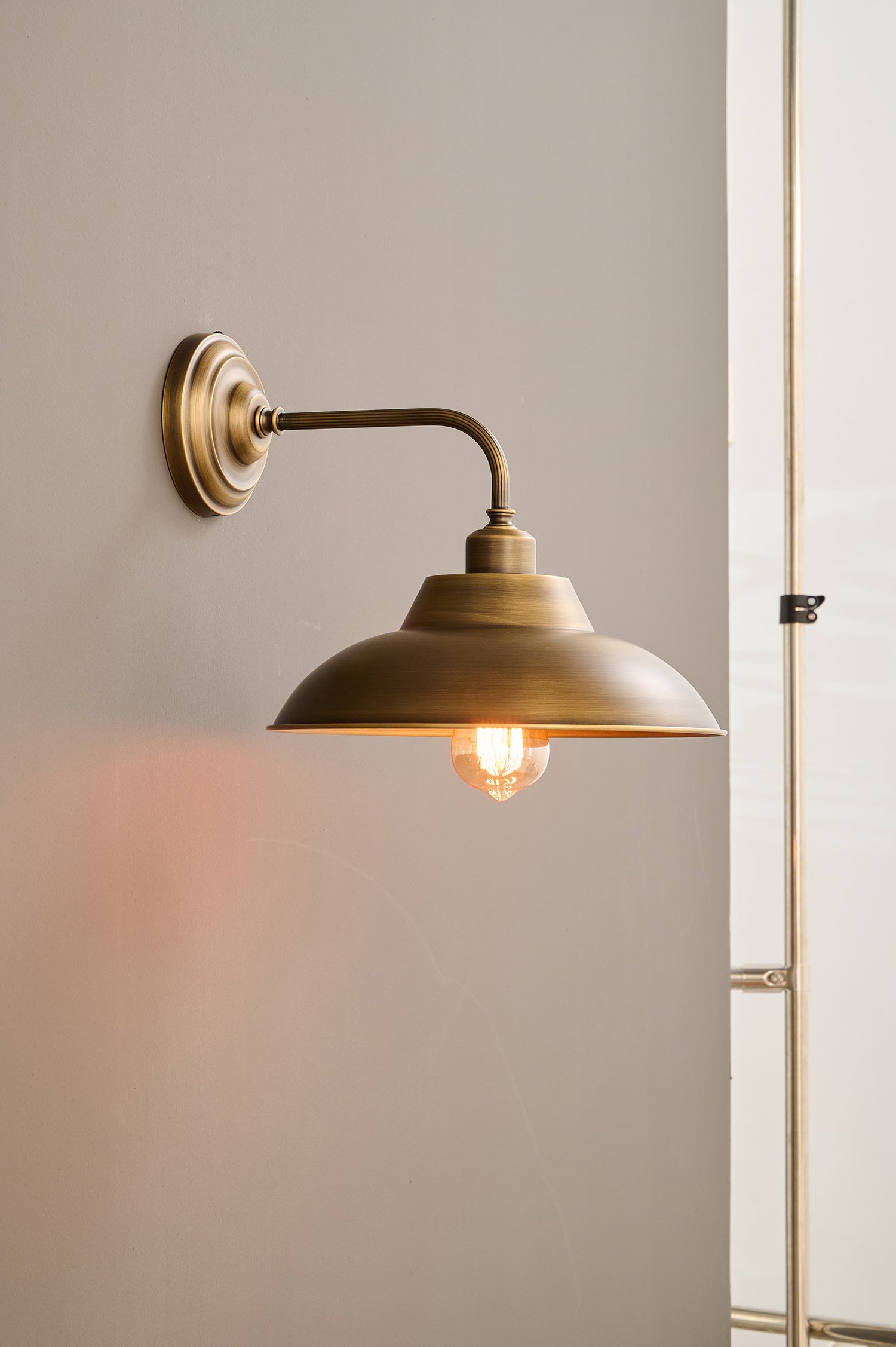 Front view of the Aldorno Wall Sconce with its wide round shade.