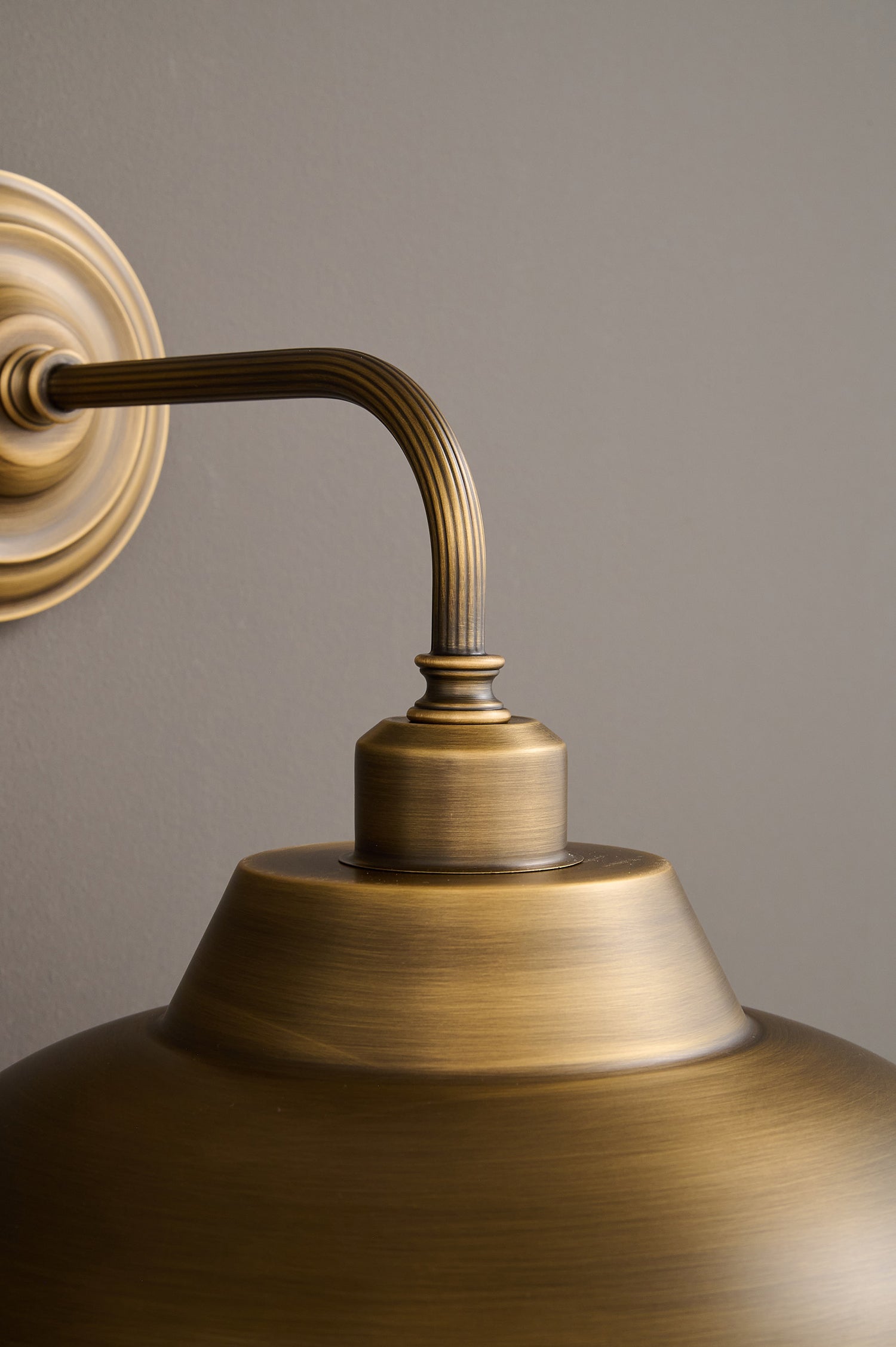Detail of the joint connecting the arm and shade of the sconce.