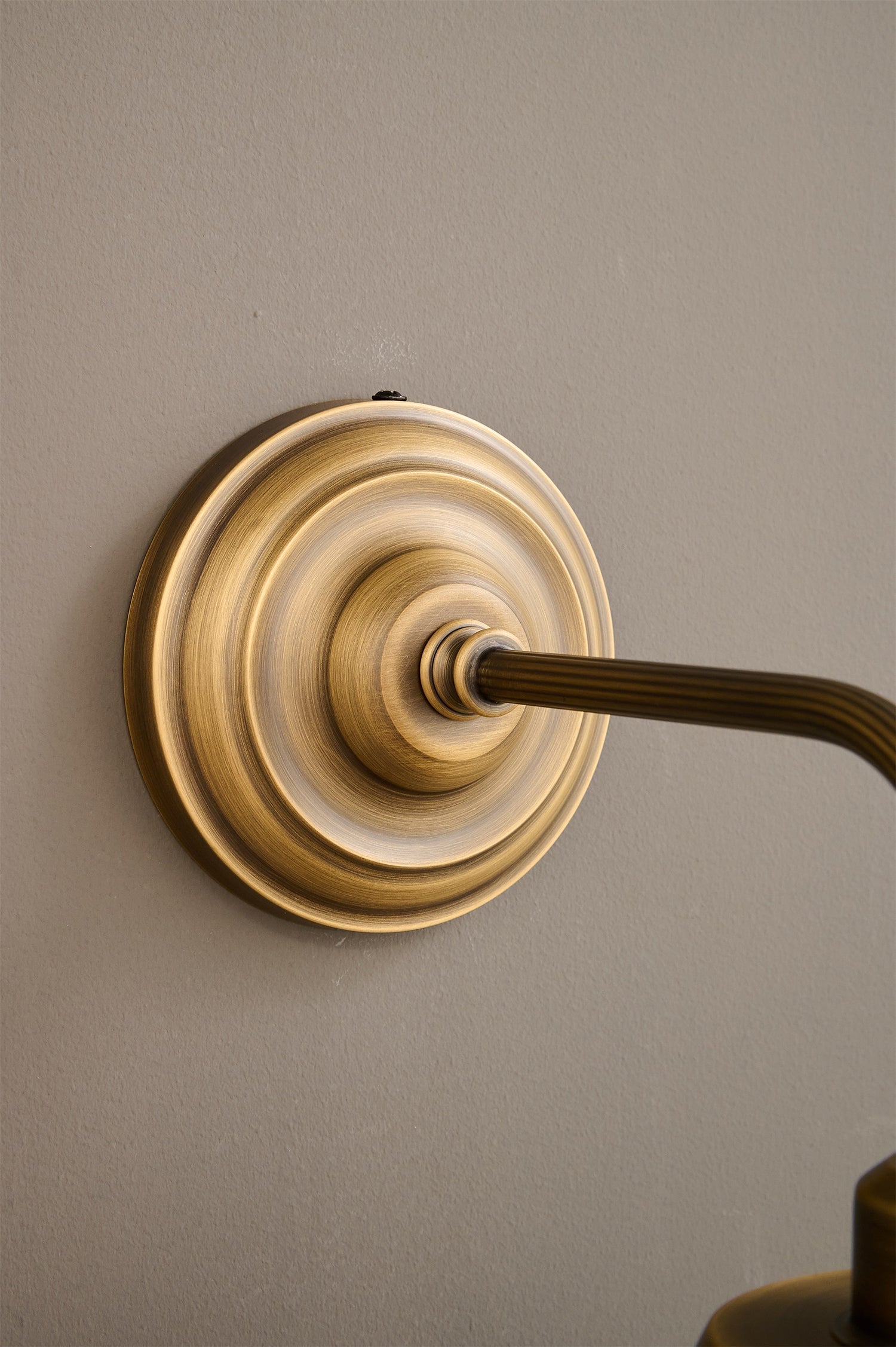 Aldorno Wall Sconce in a classic bedroom setting.