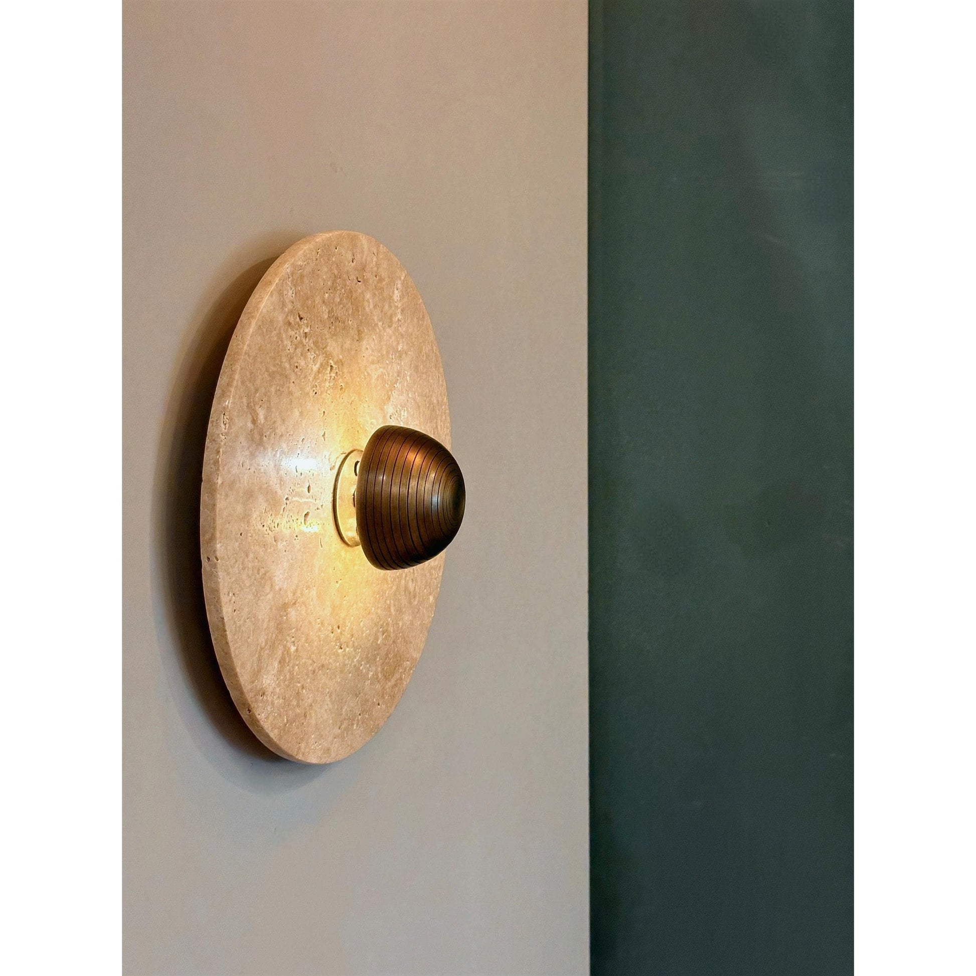 The Alese Wall Lamp illuminated, casting a warm and inviting glow.