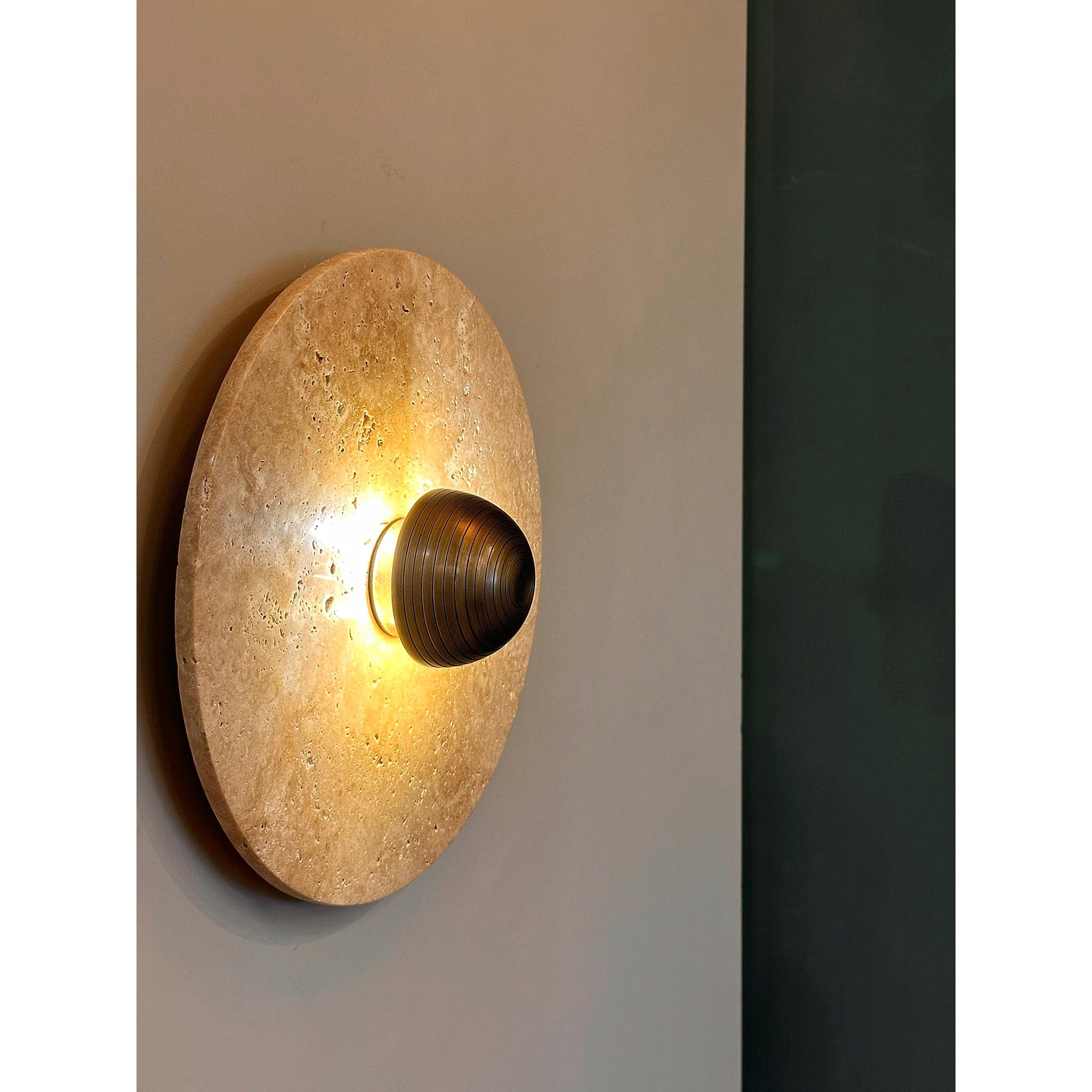 Alese Travertine Wall Lamp in a bronze finish.