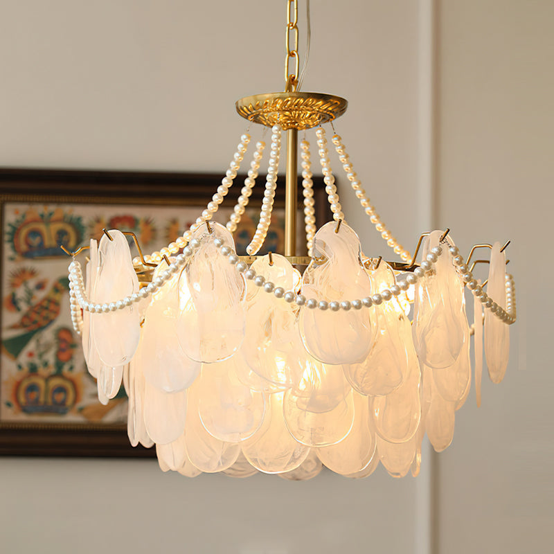 Close-up on the polished gold finish of the chandelier's metal frame.