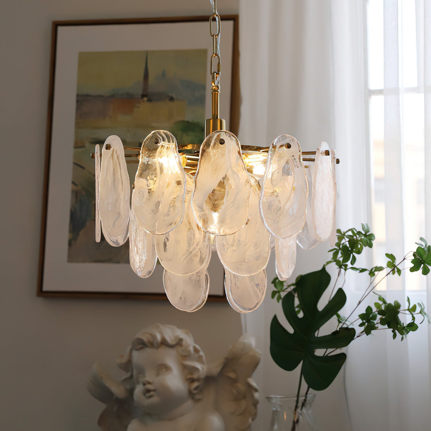 The Alessia Glass Chandelier illuminated, casting a soft, ethereal glow.