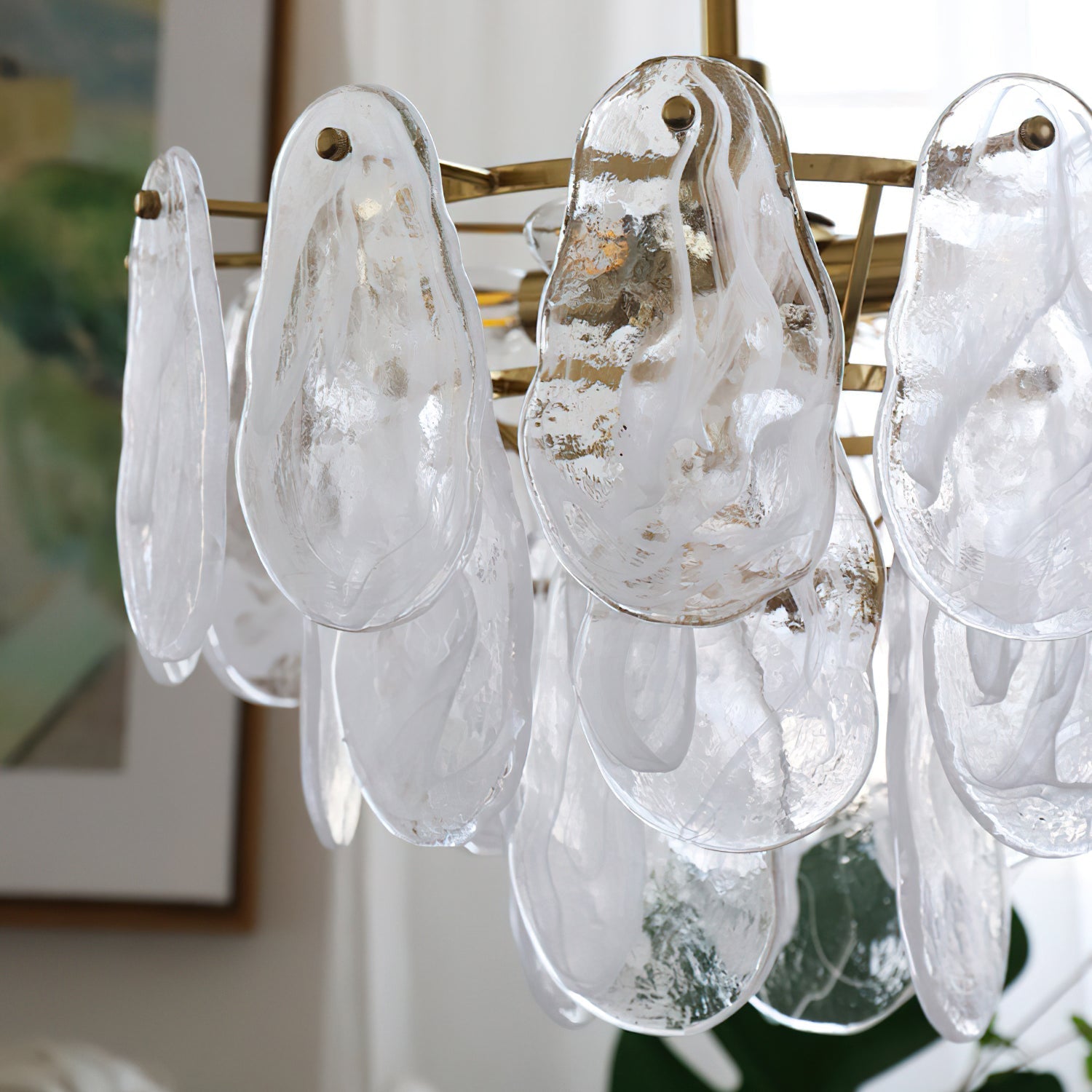 Alessia Chandelier hanging over a dining area, showcasing its size and design.