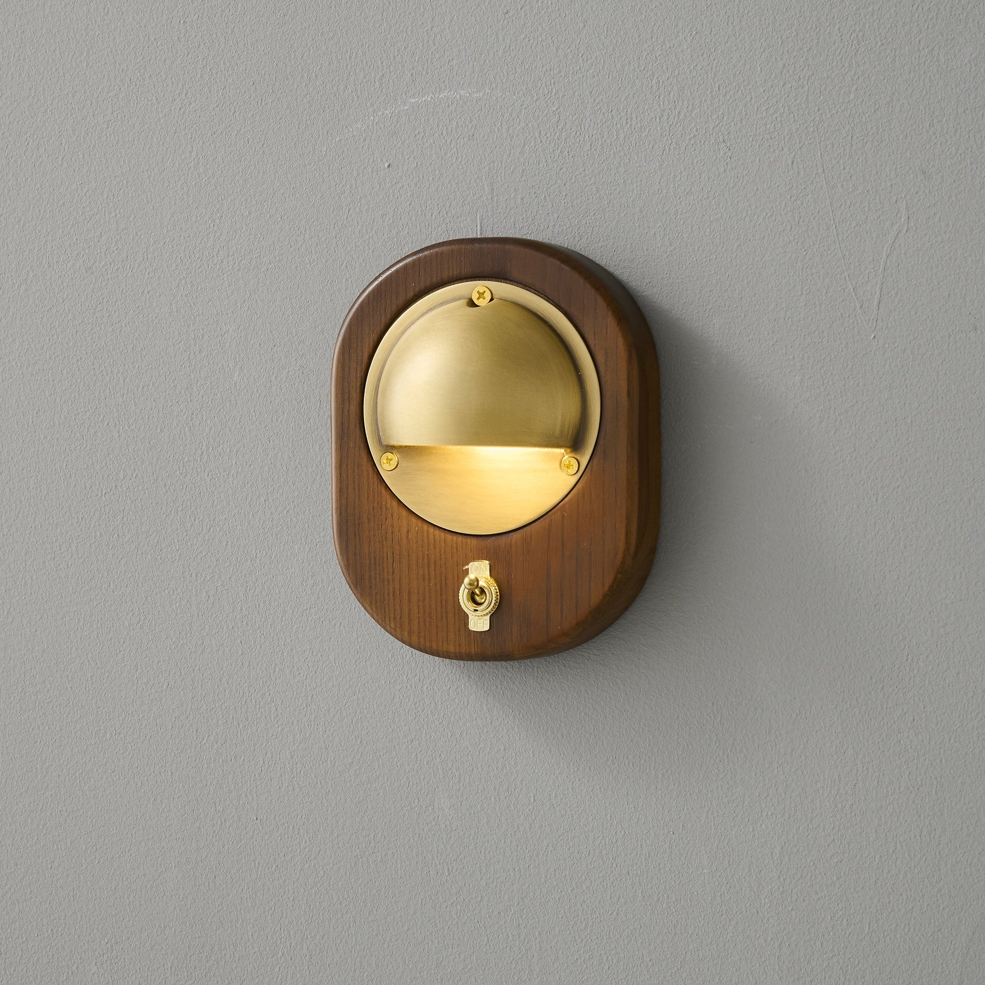 Alfi Wall Lamp, Silver finish, against a light wall.