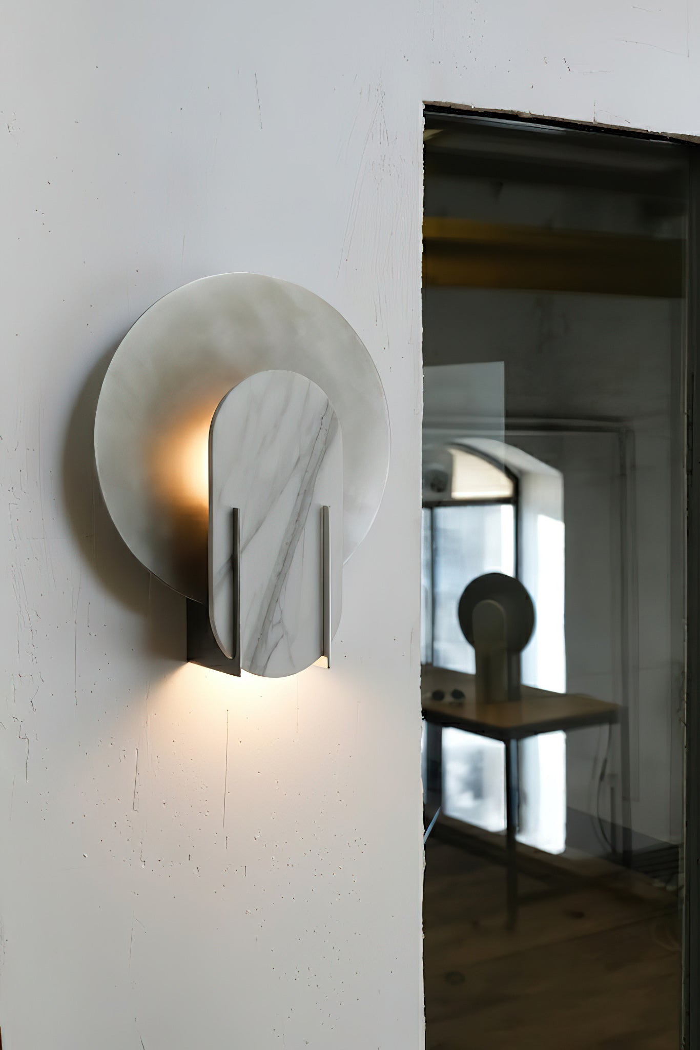 Close-up of the Alice Wall Lamp's white marble shade, highlighting its natural veining.