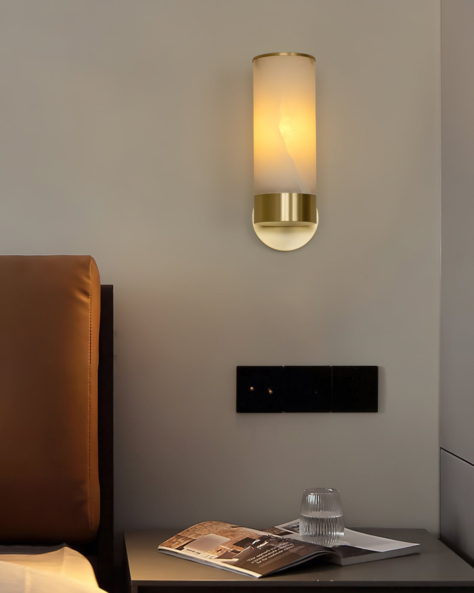 Lifestyle view of the Alistair sconce in a contemporary living room.