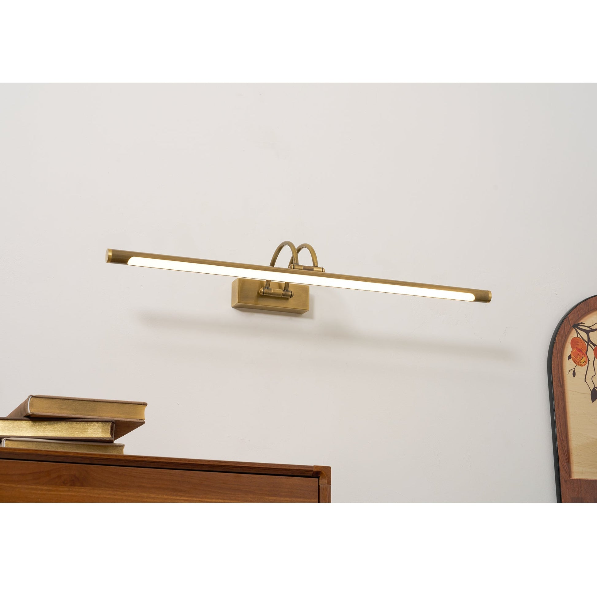Alton wall lamp illuminating artwork in a modern living room.