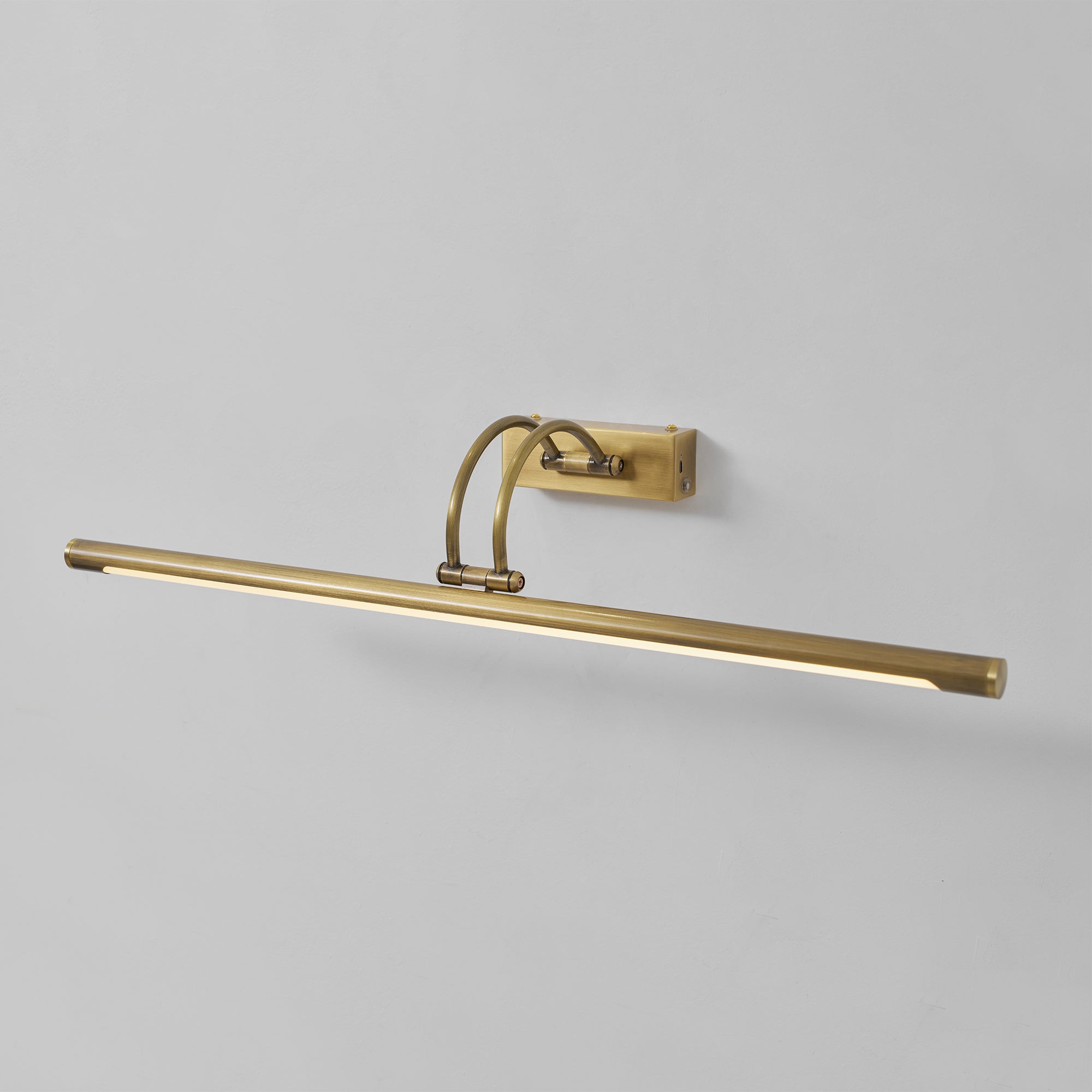 Alton rechargeable wall lamp in antique brass finish, angled view.