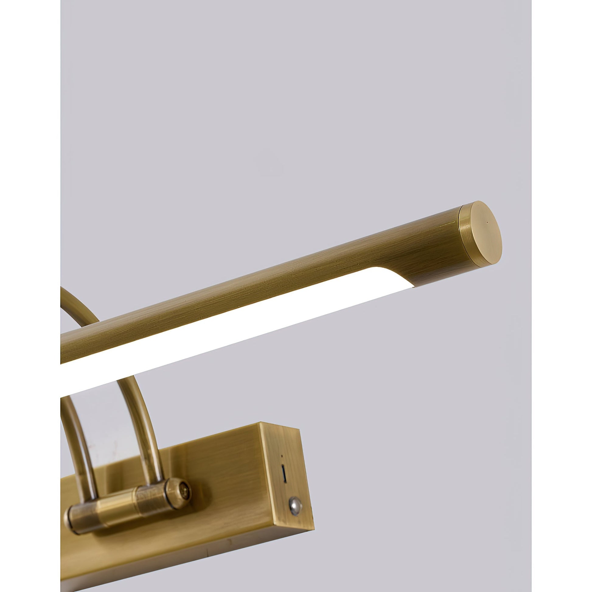 Lifestyle image of the Alton brass lamp over a bookshelf.