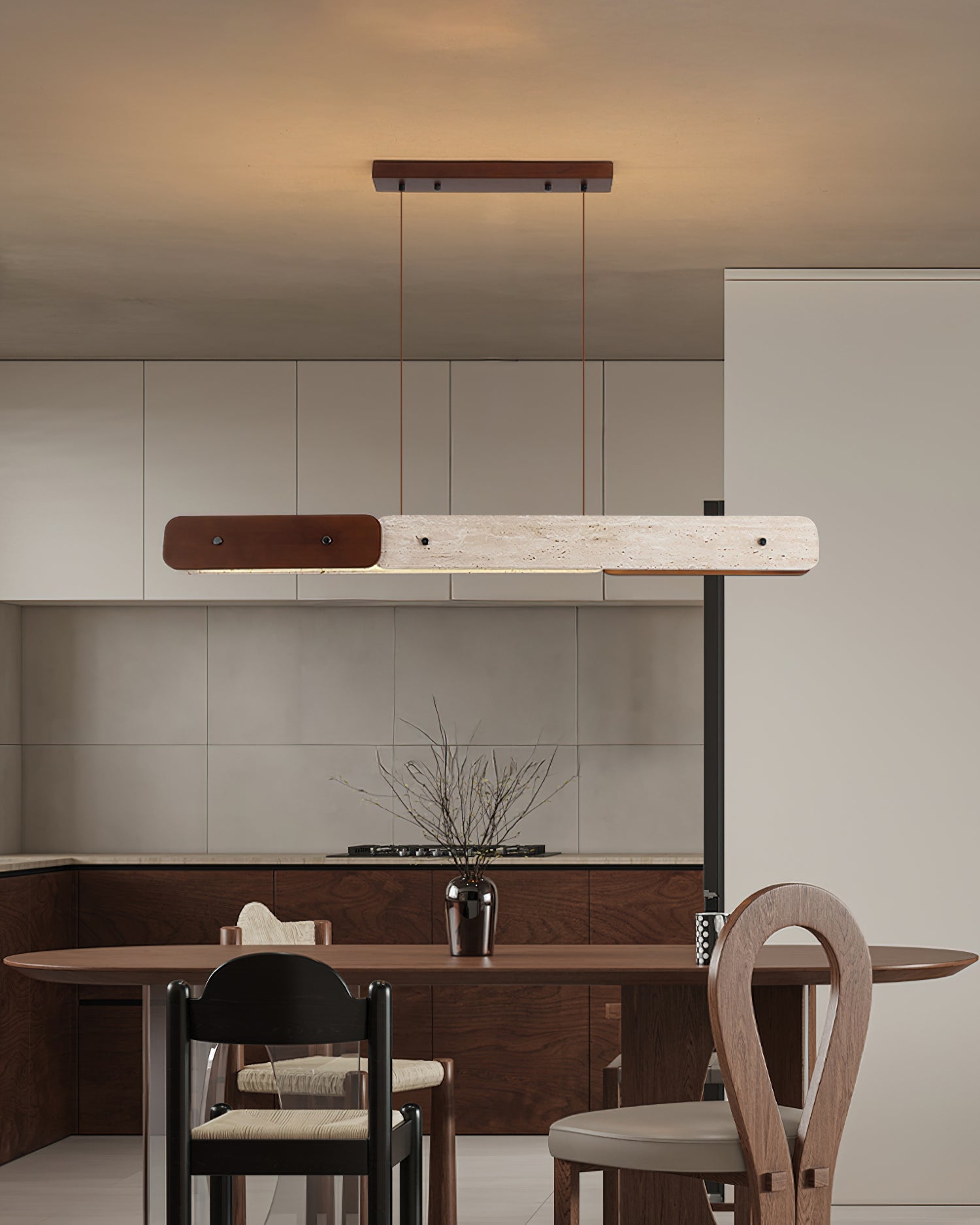 The linear chandelier illuminated, casting a warm and even glow in a room.
