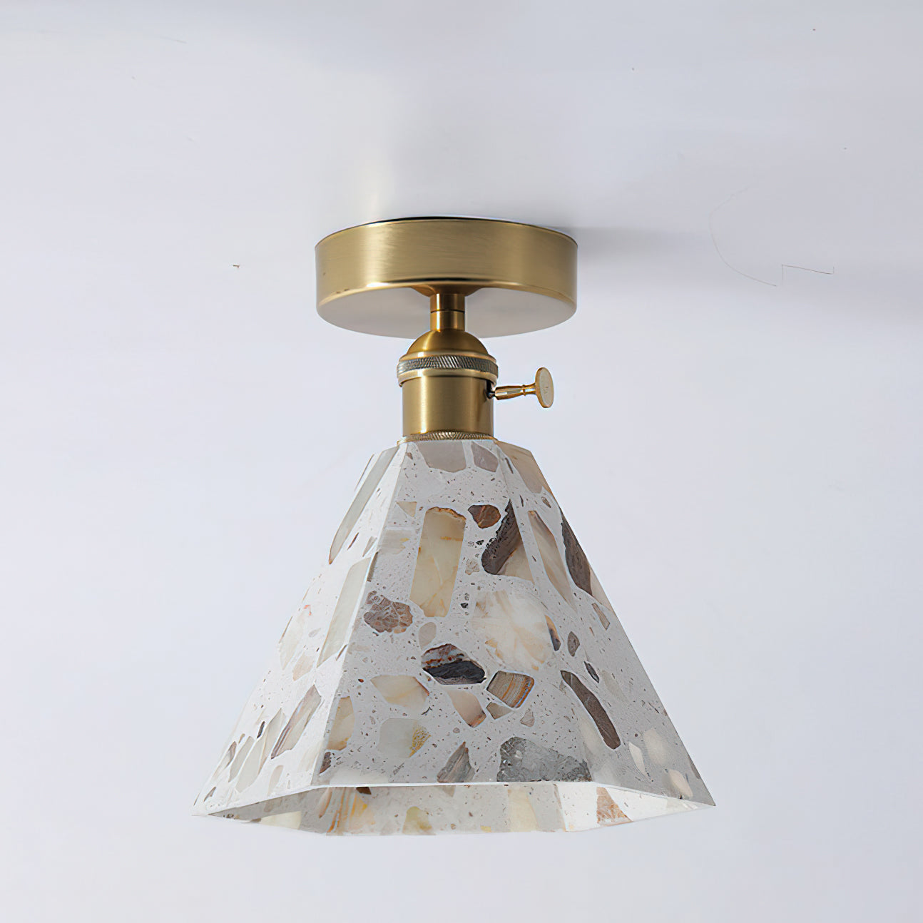 The gold mounting plate of the Alvaro Ceiling Lamp.