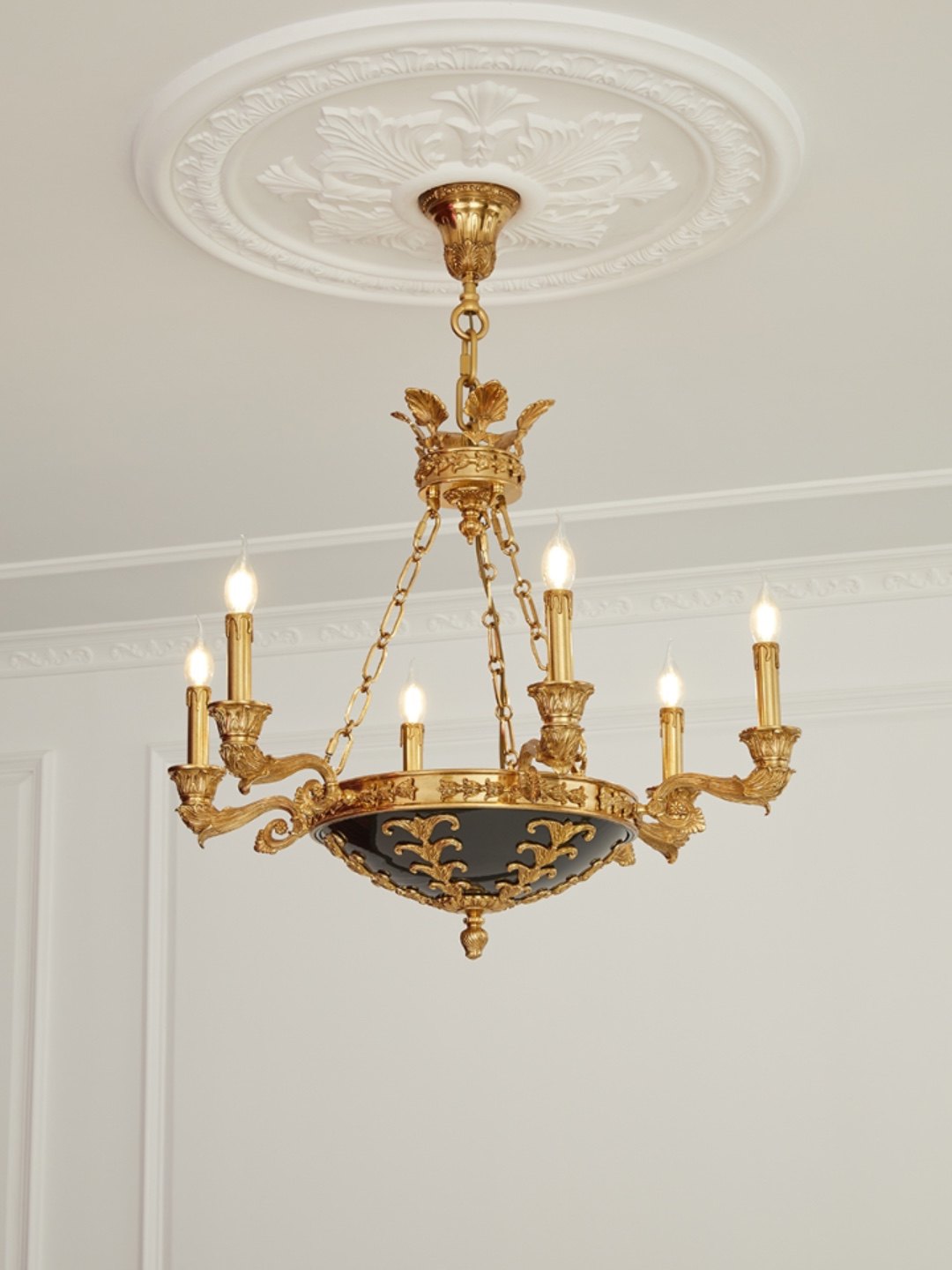 The Amelie Grand Chandelier with a brass and black finish in a transitional interior.