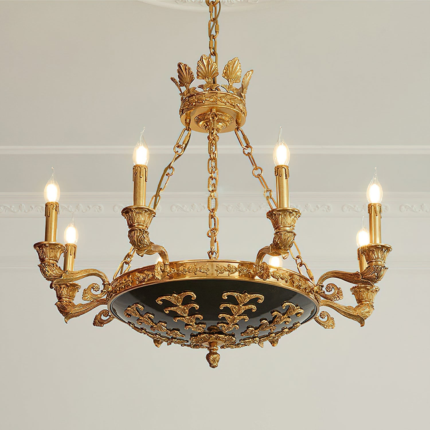The chandelier illuminating a grand foyer space.