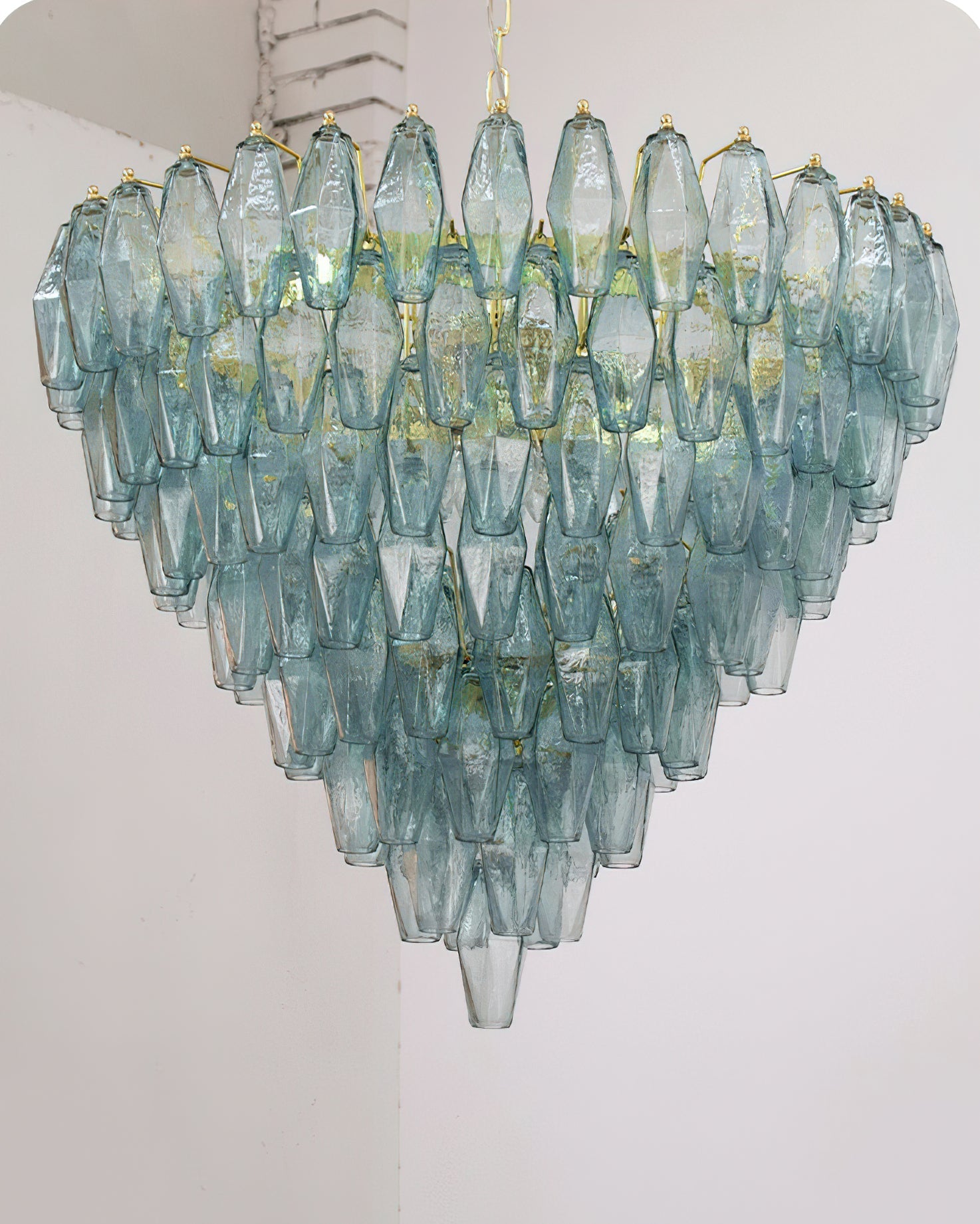 Ametista Chandelier with purple glass prisms against a dark, dramatic wall.