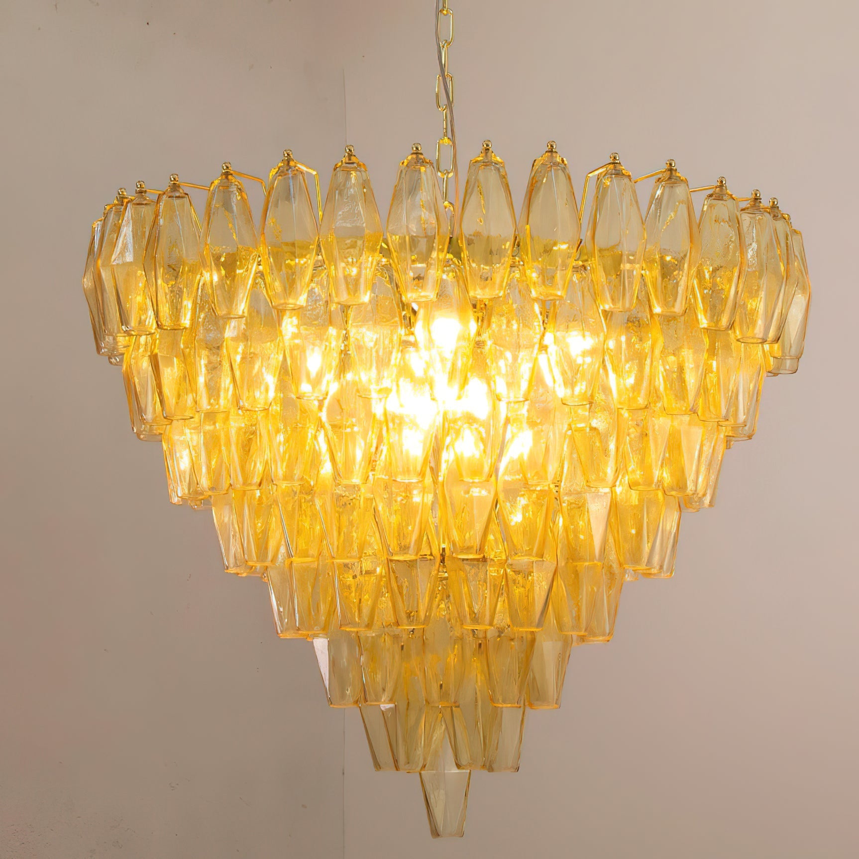 Ametista Chandelier with blue glass prisms hanging over a dining table.
