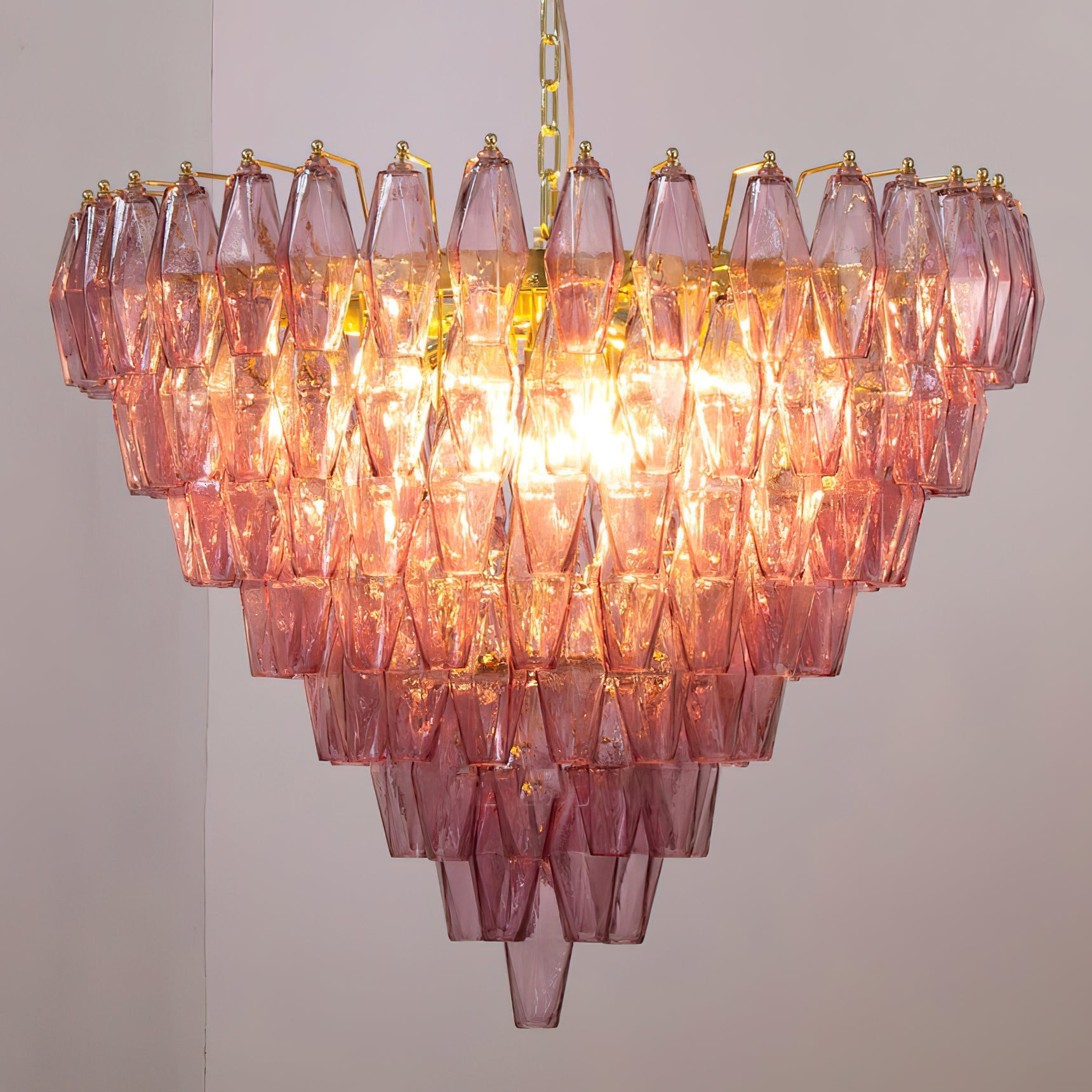 Close-up view of the interlocking polyhedral glass prisms of the Ametista Chandelier.