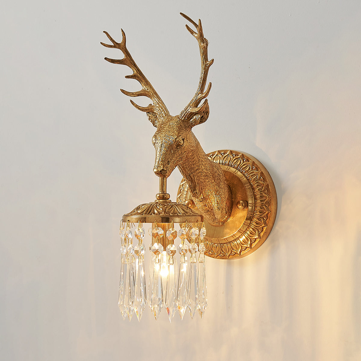 The stag head sculpture as the central feature of the lamp.
