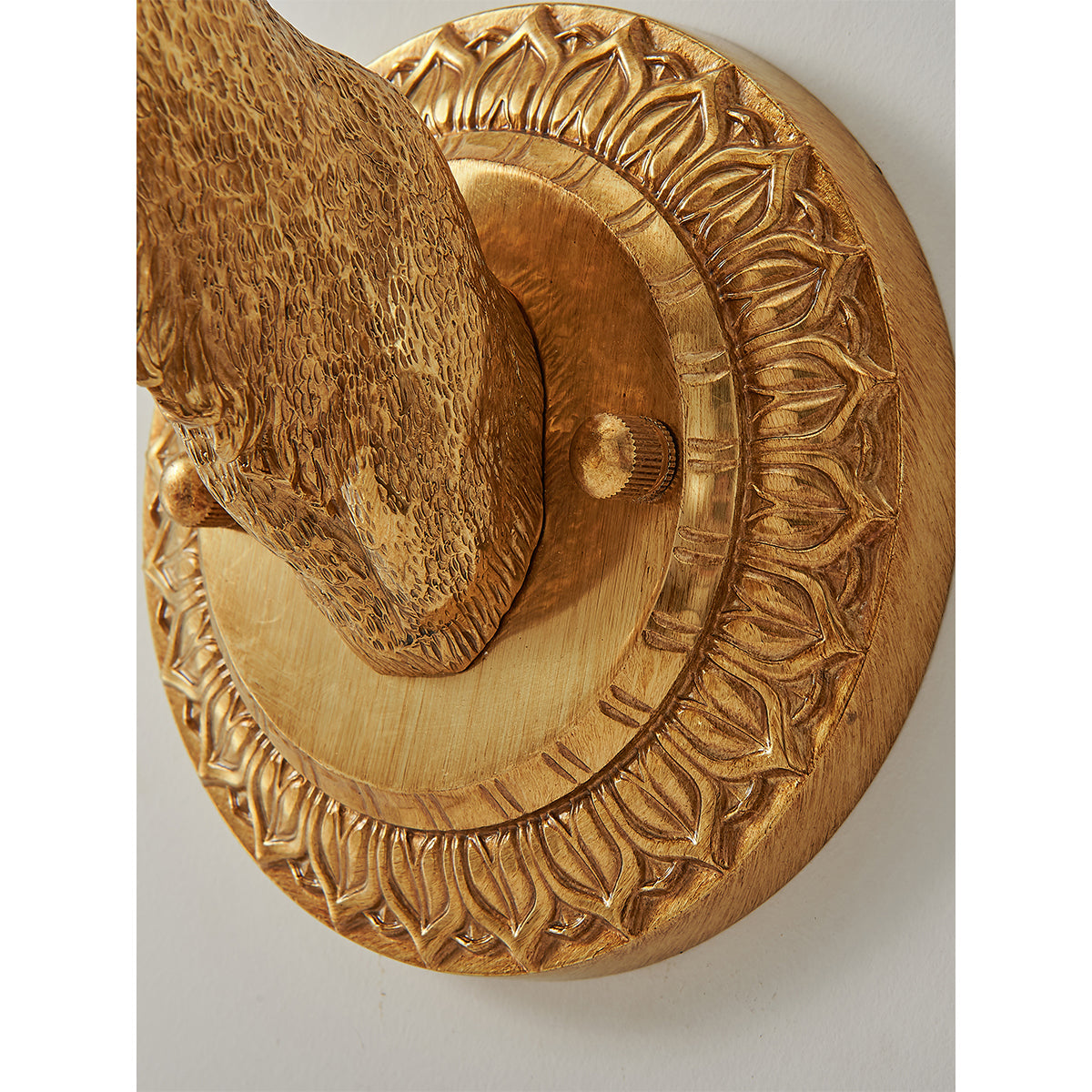 The interplay of light and shadow created by the illuminated sconce.