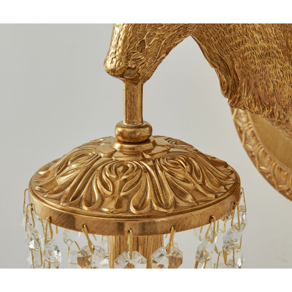 The wall sconce against a textured wallpaper.