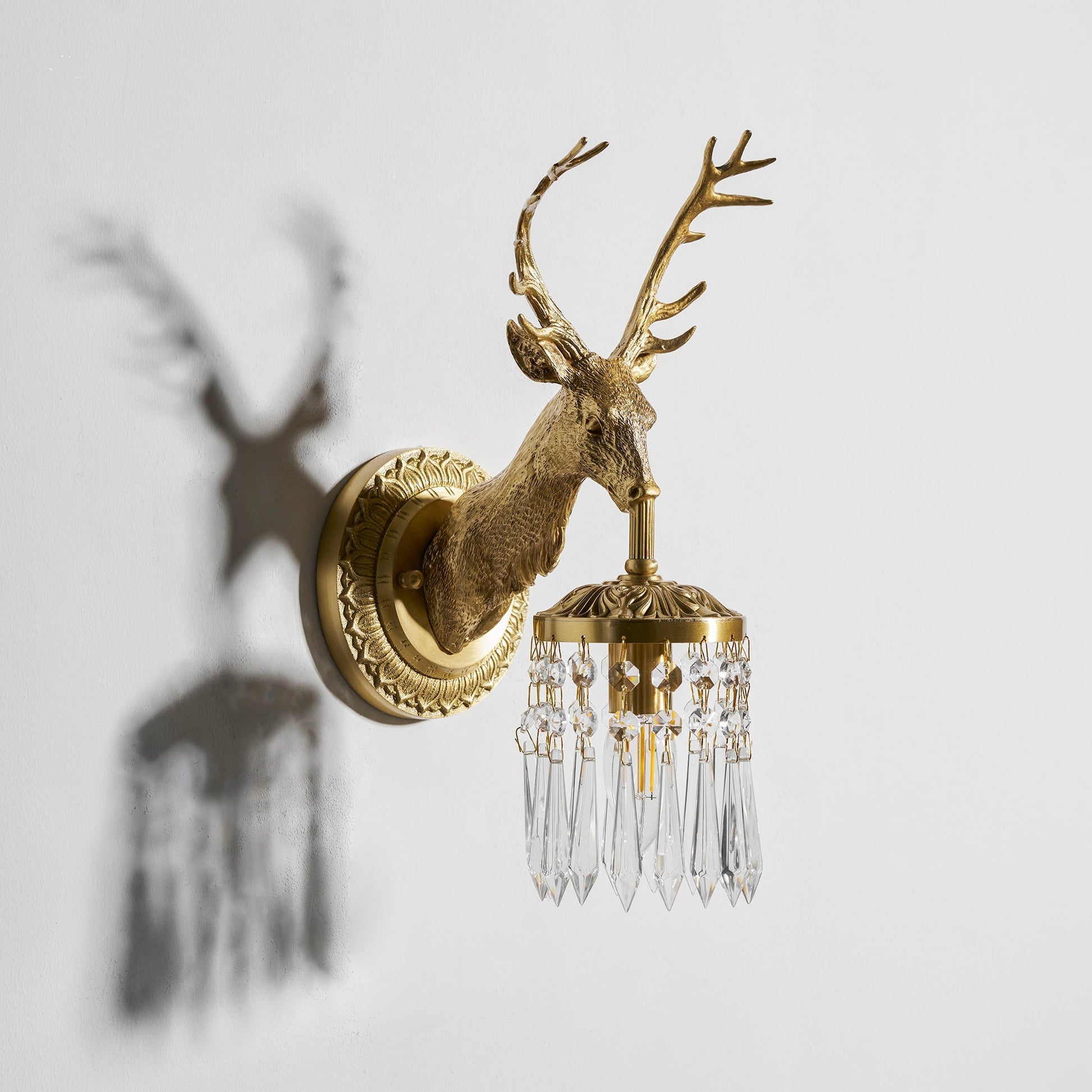 The elegant silhouette of the Antler Crystal Wall Lamp.