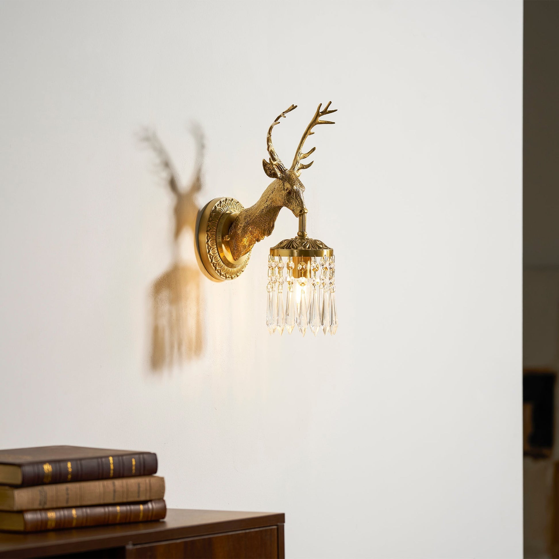 Front view of the Antler Crystal Wall Lamp against a dark wall.
