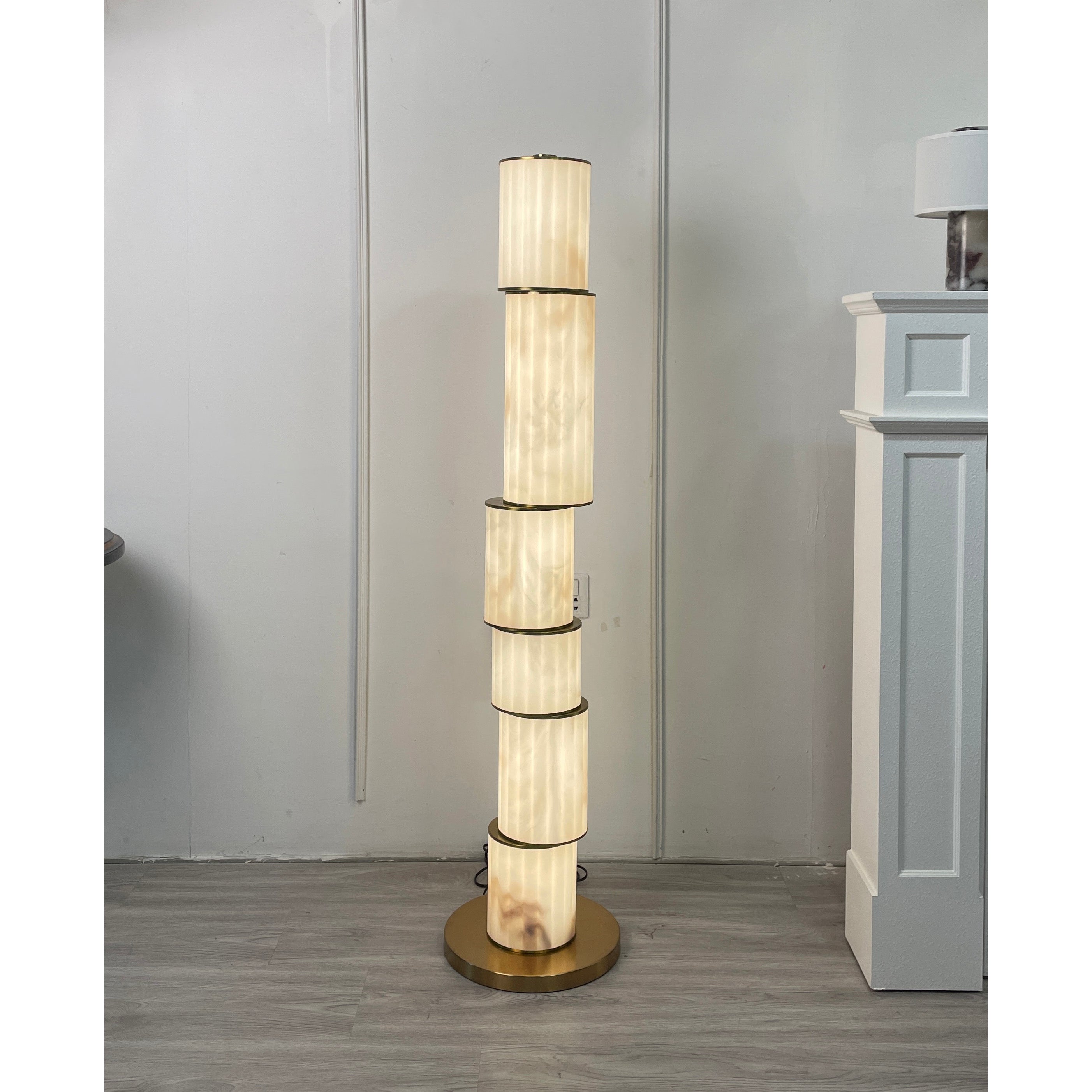 Close-up of the top of the Apadana floor lamp, showing the alabaster and bronze details.