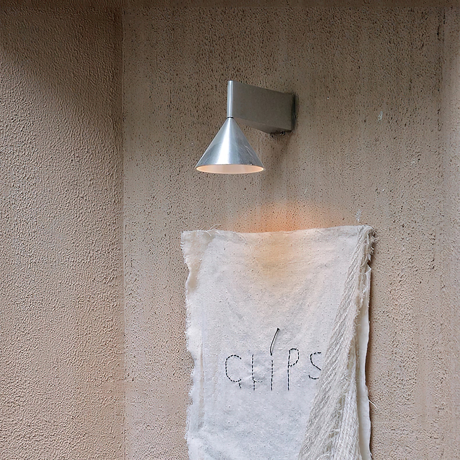 Close-up of the aluminum texture on the Apollo Wall Lamp.