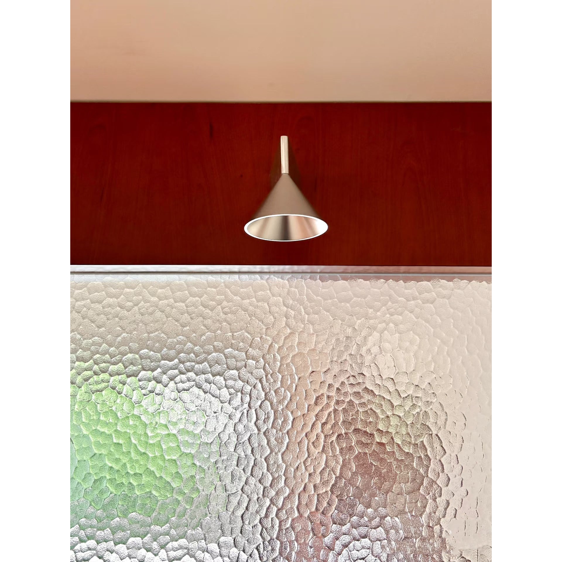 The Apollo Wall Lamp installed in a minimalist hallway.