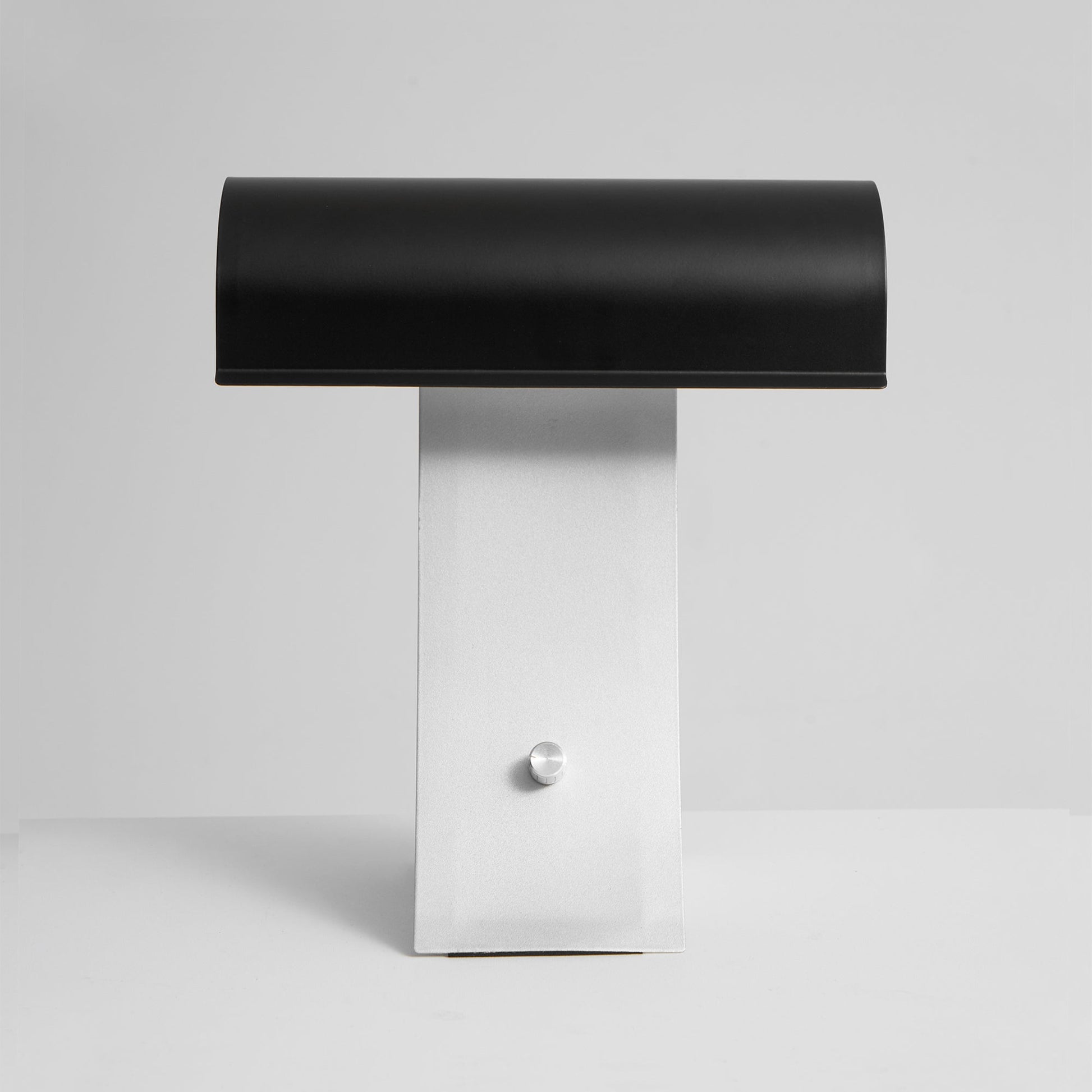 The Archive Table Lamp turned on, casting a warm light.