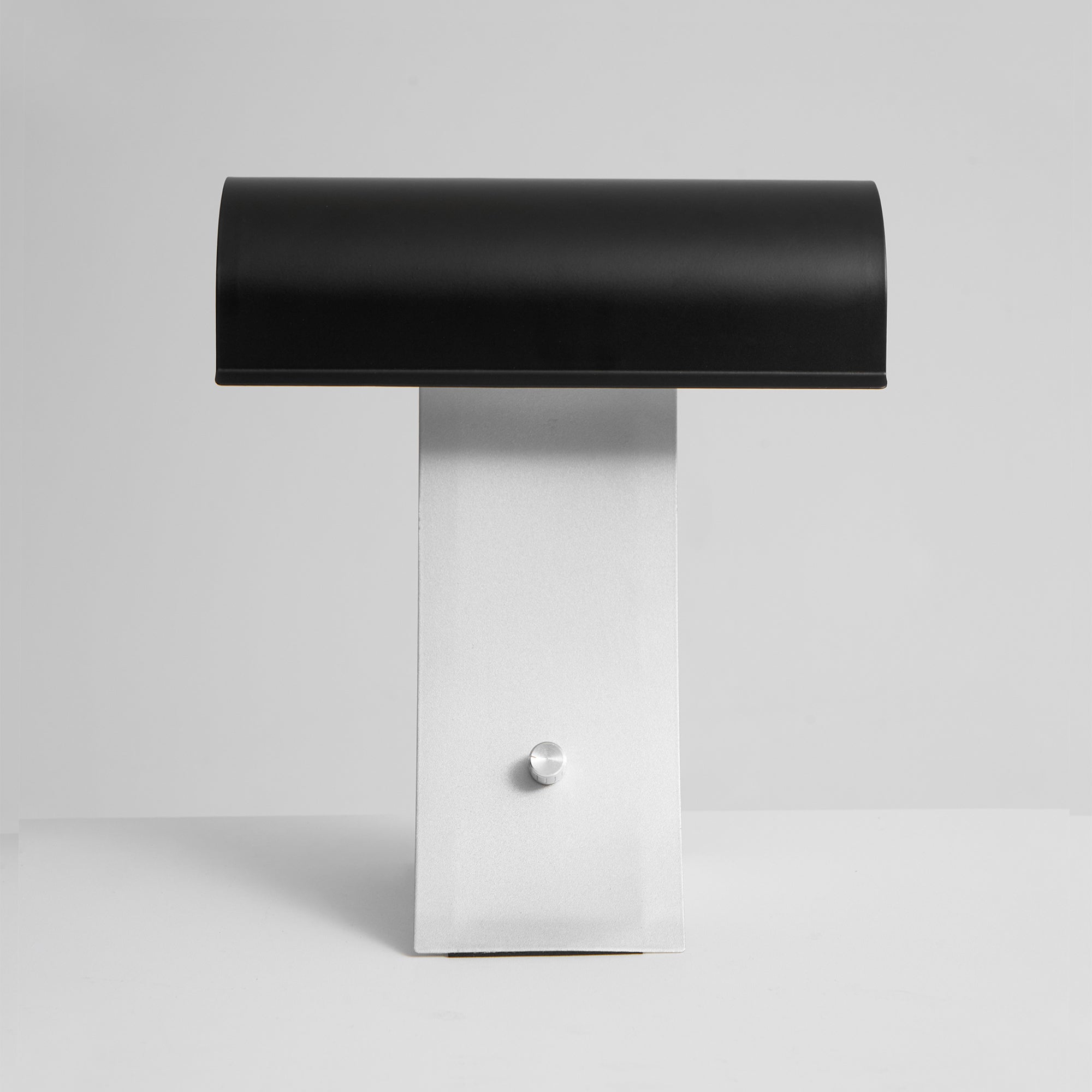 The Archive Table Lamp turned on, casting a warm light.