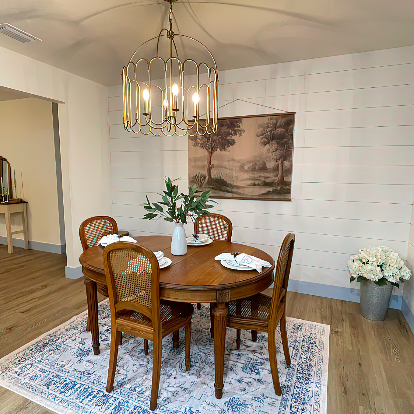 Lifestyle view of the Argente Chandelier hanging in a modern living room.